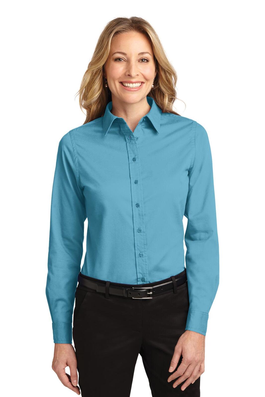 A women's long sleeve button-up shirt in a vibrant teal colour, featuring a collar and a branded logo.