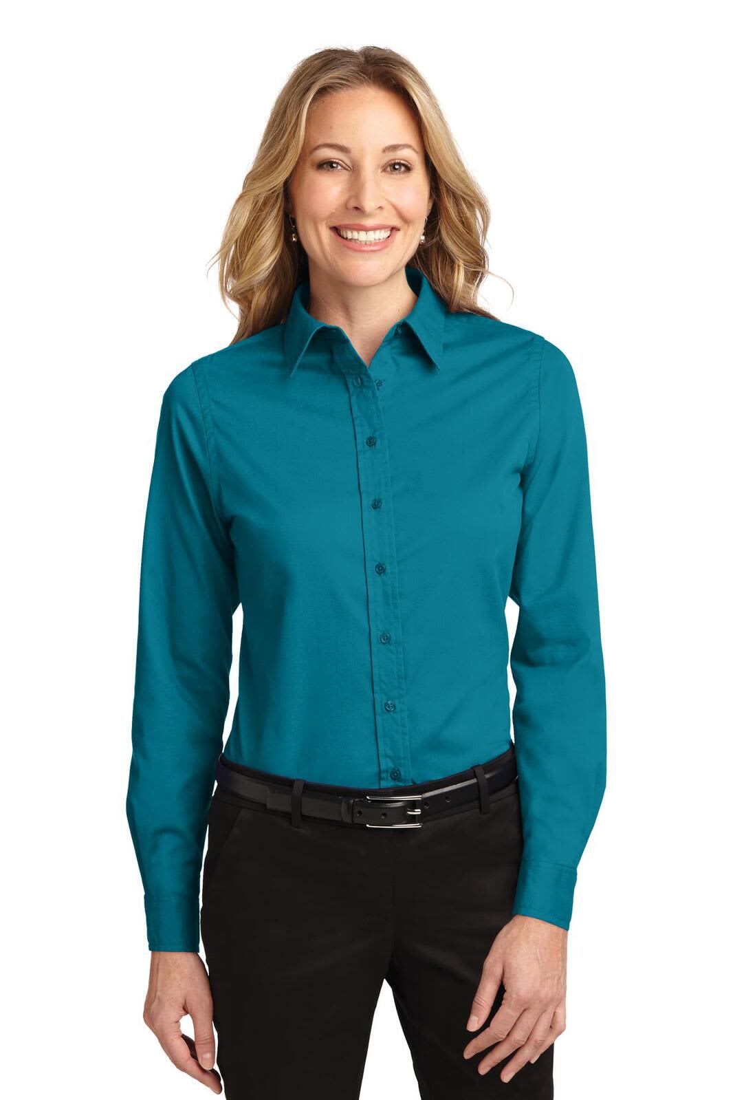 A long sleeve button-up shirt in teal, featuring a collar and a button front, worn by a smiling woman.