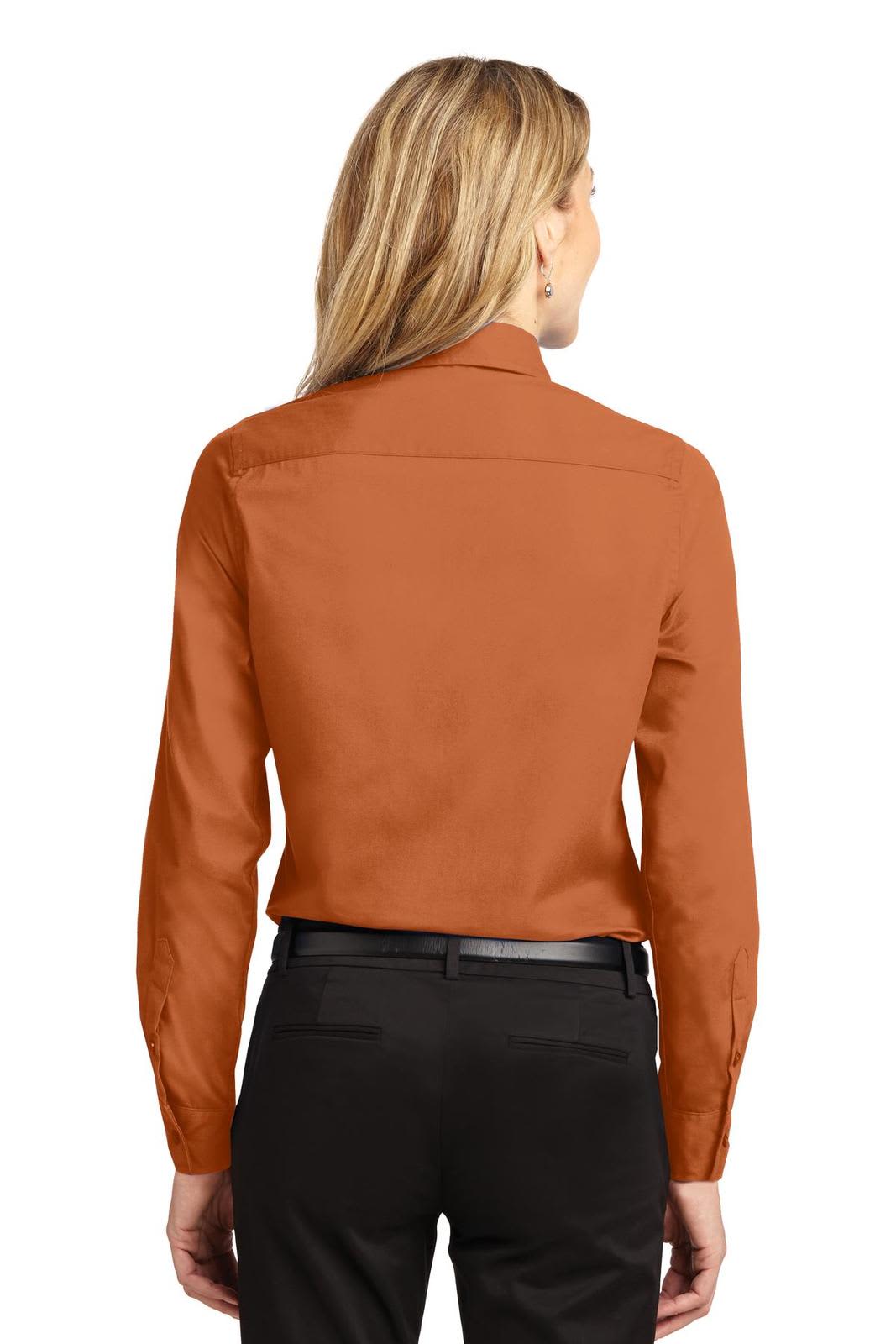 A back view of a women's long sleeve button-up shirt in a warm rust colour, featuring a collar and fitted design.