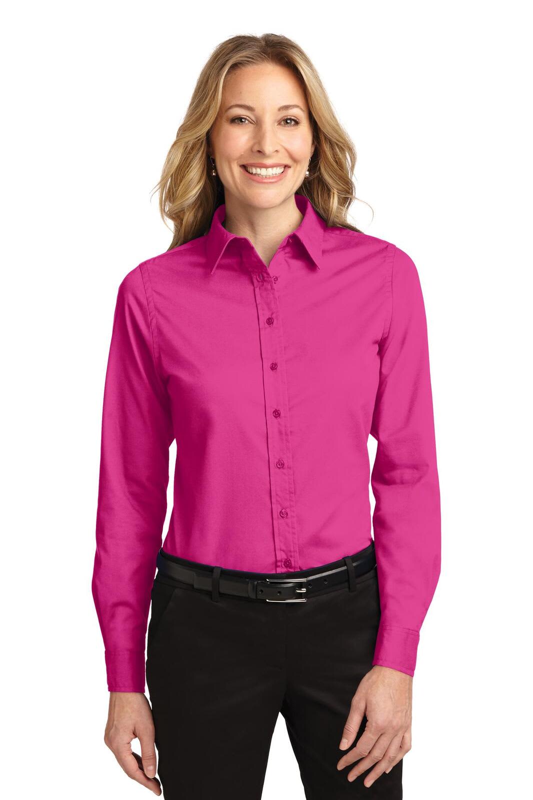 A pink long sleeve button-up shirt for women, featuring a collar and a branding logo.