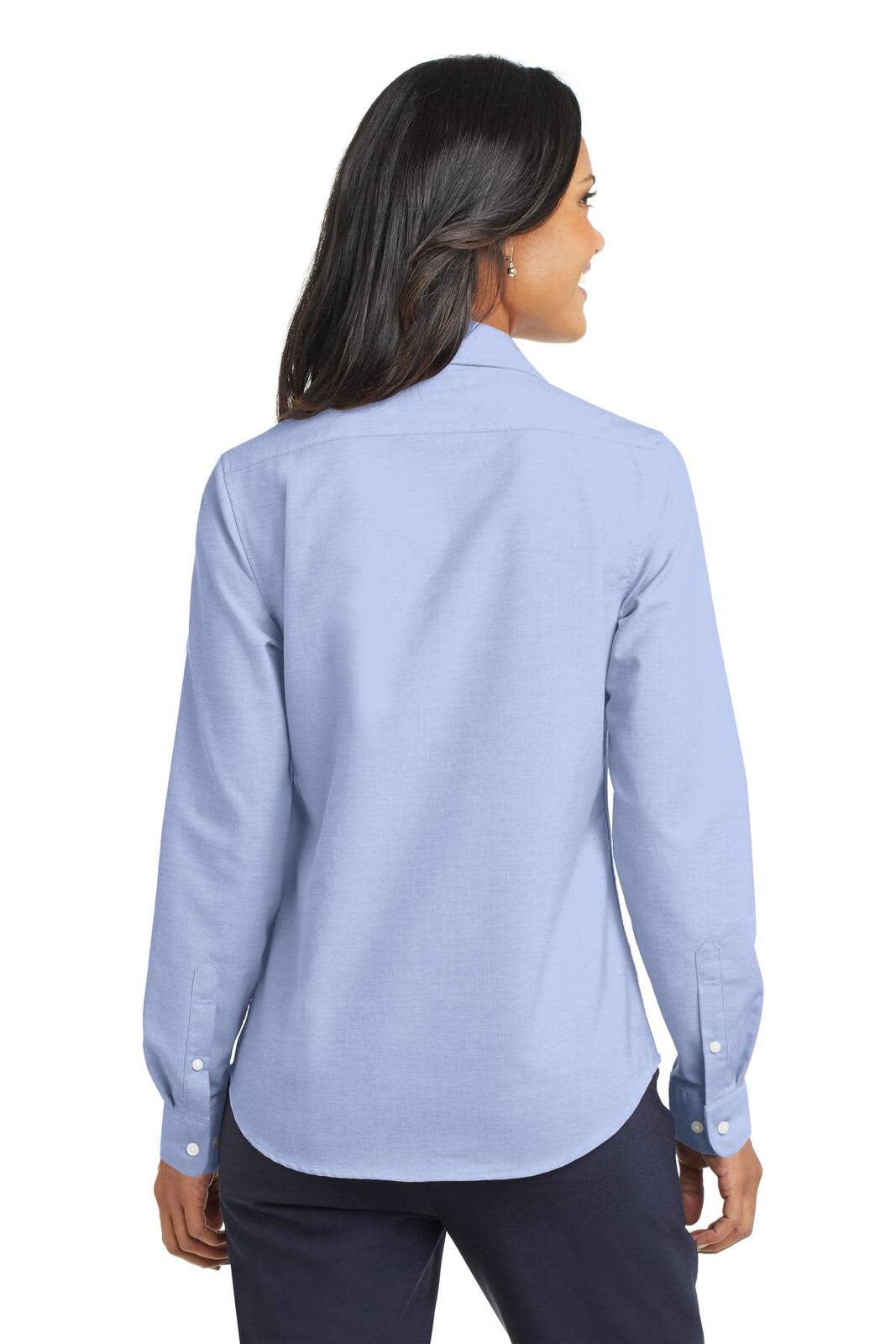 A light blue button-up shirt with long sleeves and a collar, featuring a logo on the back.