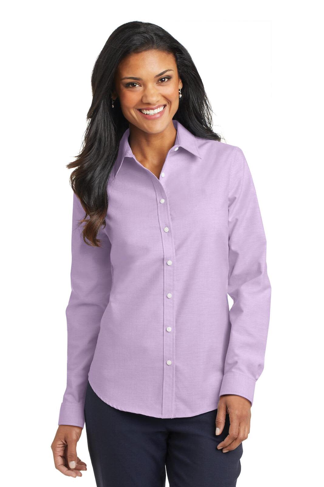 A woman in a light purple button-up shirt with a collar, featuring long sleeves and a logo.