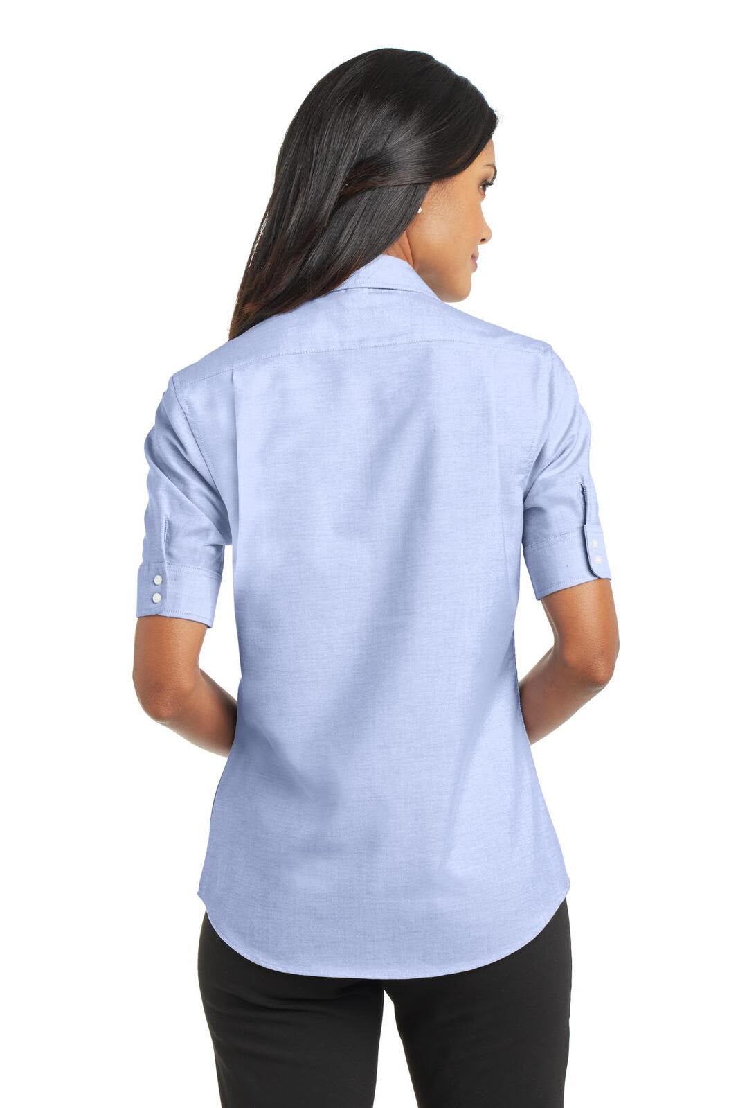 A light blue button-up shirt with short sleeves, featuring a back view and a subtle logo.