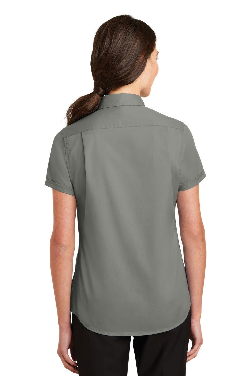 A woman wearing a short sleeve, button-up shirt in grey with a collar and a branded logo on the back.