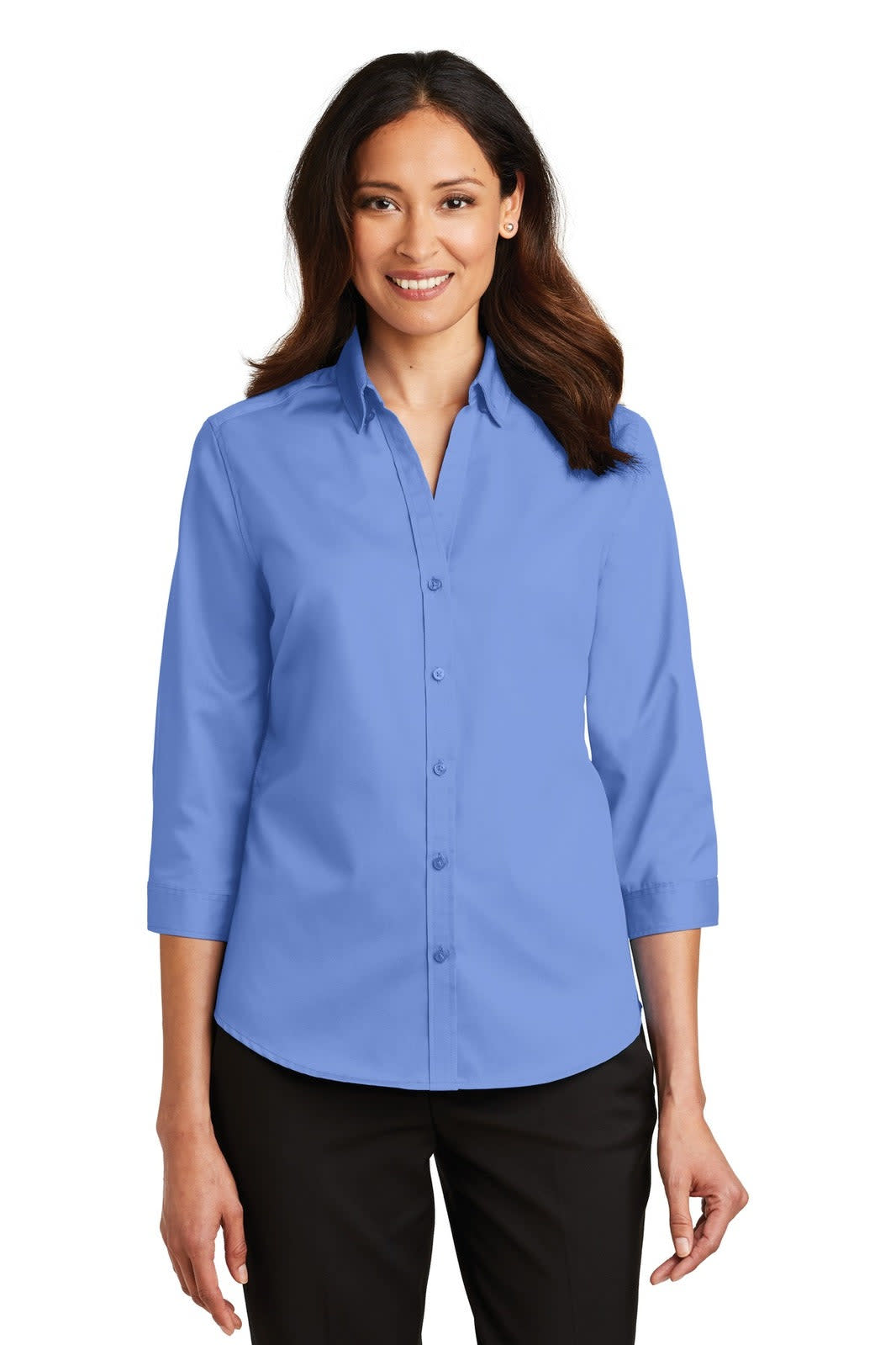 A woman wearing a light blue button-up shirt with 3/4 sleeves, showcasing a collar and a branding logo.