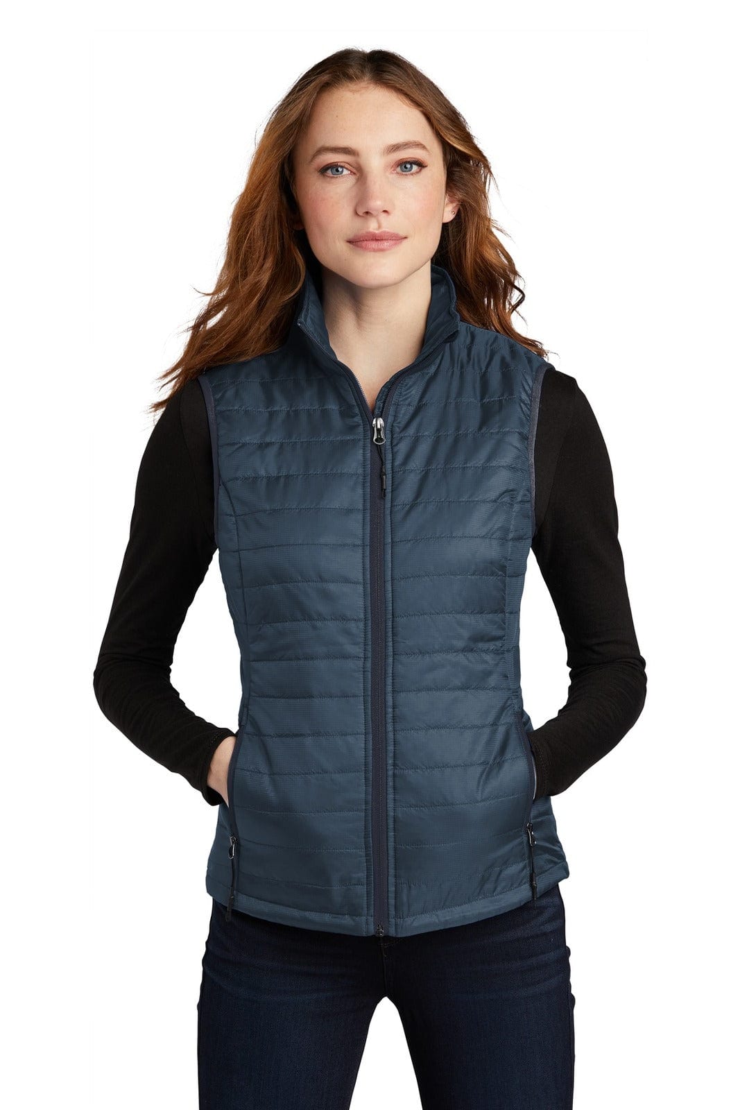 A navy packable puffy vest with a front zip and side pockets, worn over a black long-sleeve top.