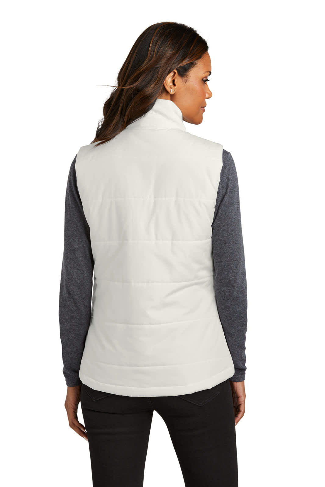 A lady wearing a white puffer vest, viewed from the back, paired with a grey long-sleeve top and dark pants.