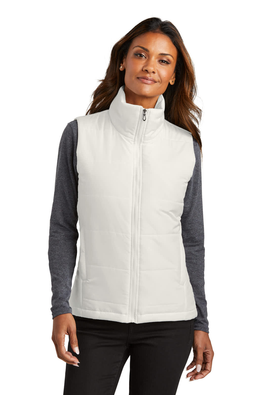 A light-coloured ladies puffer vest with a high collar and zip front, worn over a long-sleeved top. Features a logo.