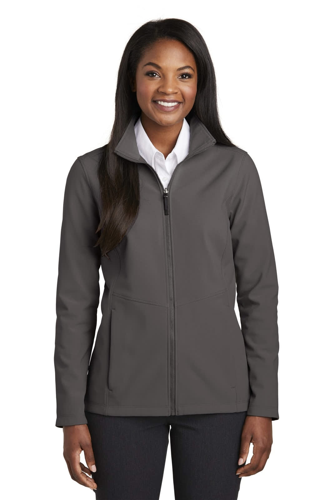 A soft shell jacket in a dark grey colour, featuring a full zip and a standing collar, worn by a woman.