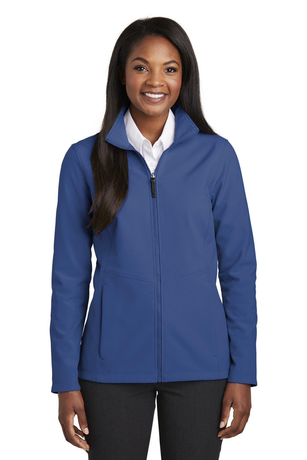 A blue Port Authority Ladies Collective Soft Shell Jacket displayed on a model standing with a smile. The jacket has a logo.