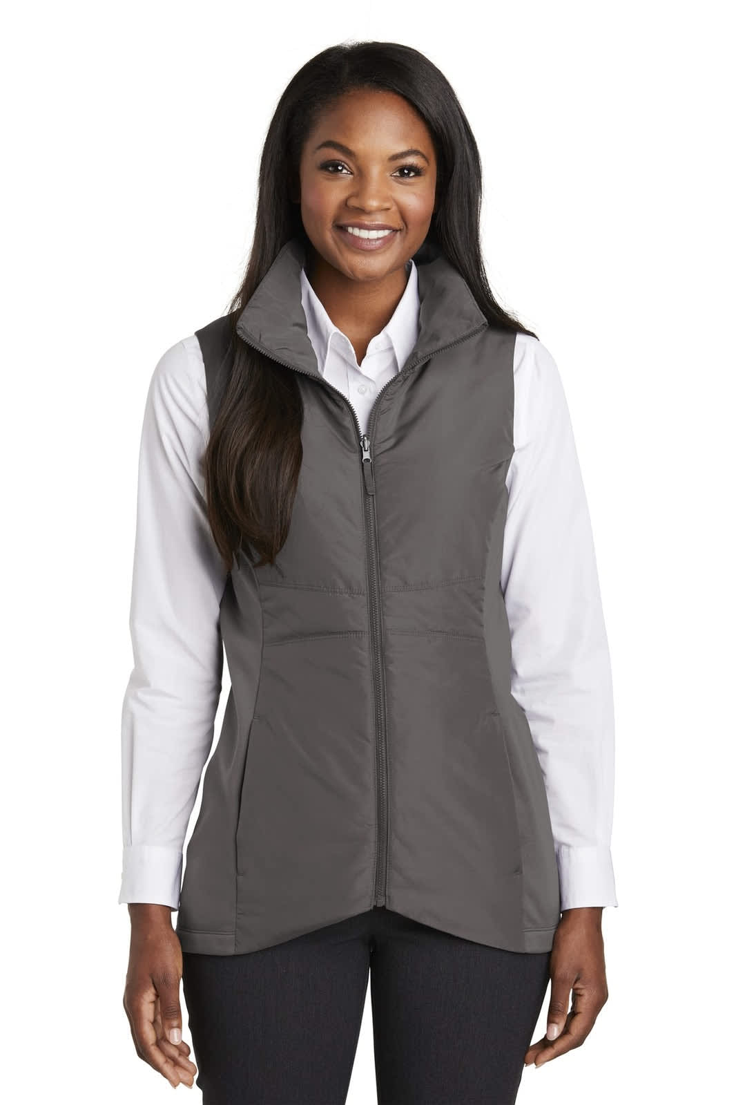 A grey insulated vest with a zip front and high collar, worn over a white shirt. It features a logo on the chest.