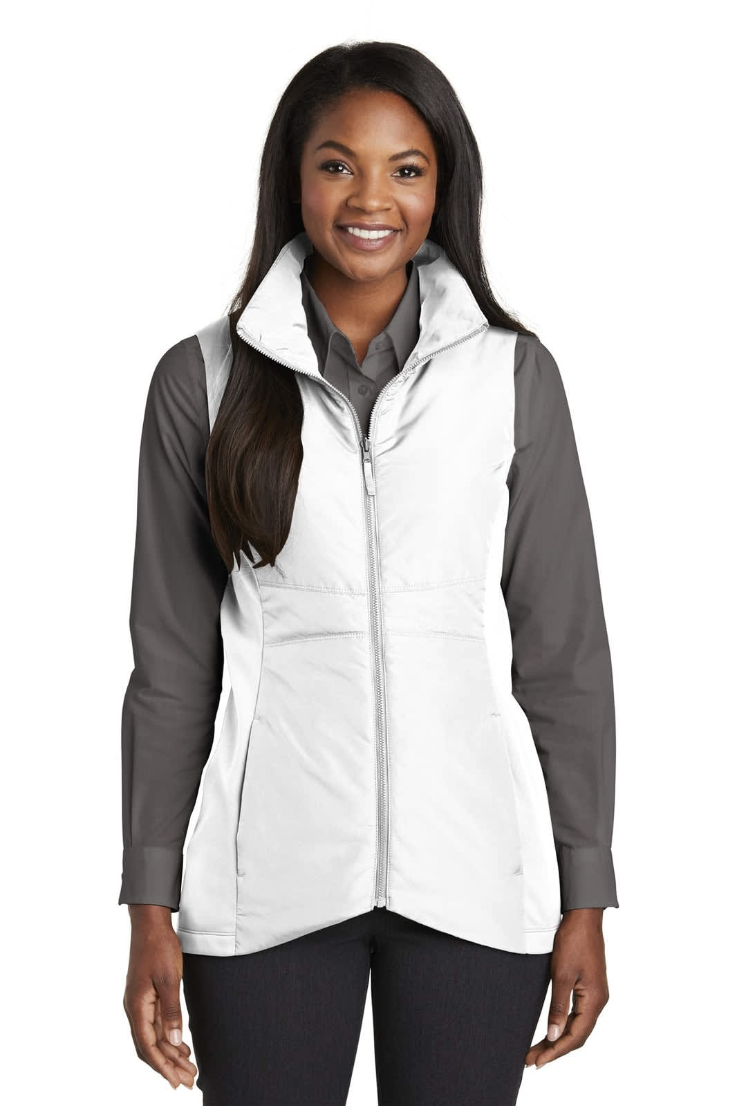 A woman is wearing a white insulated vest over a grey shirt, featuring a logo. The vest has a zip front and a stand collar.