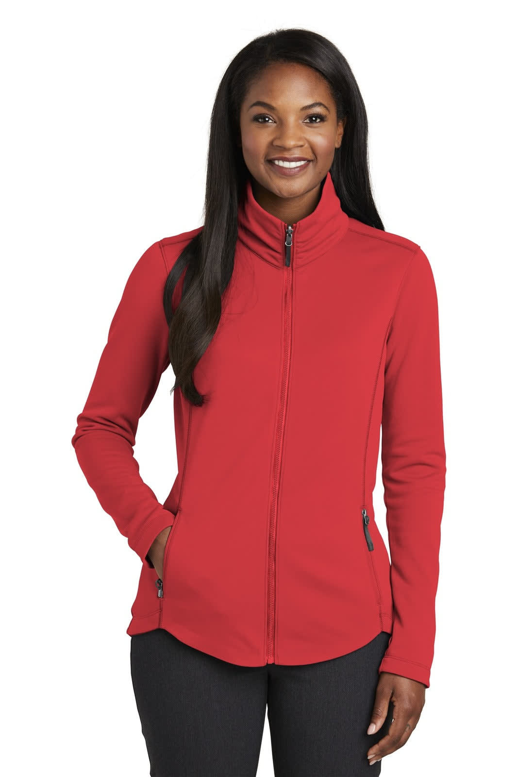 A red fleece jacket with a full zip, featuring a stand-up collar and side pockets, modelled by a woman.