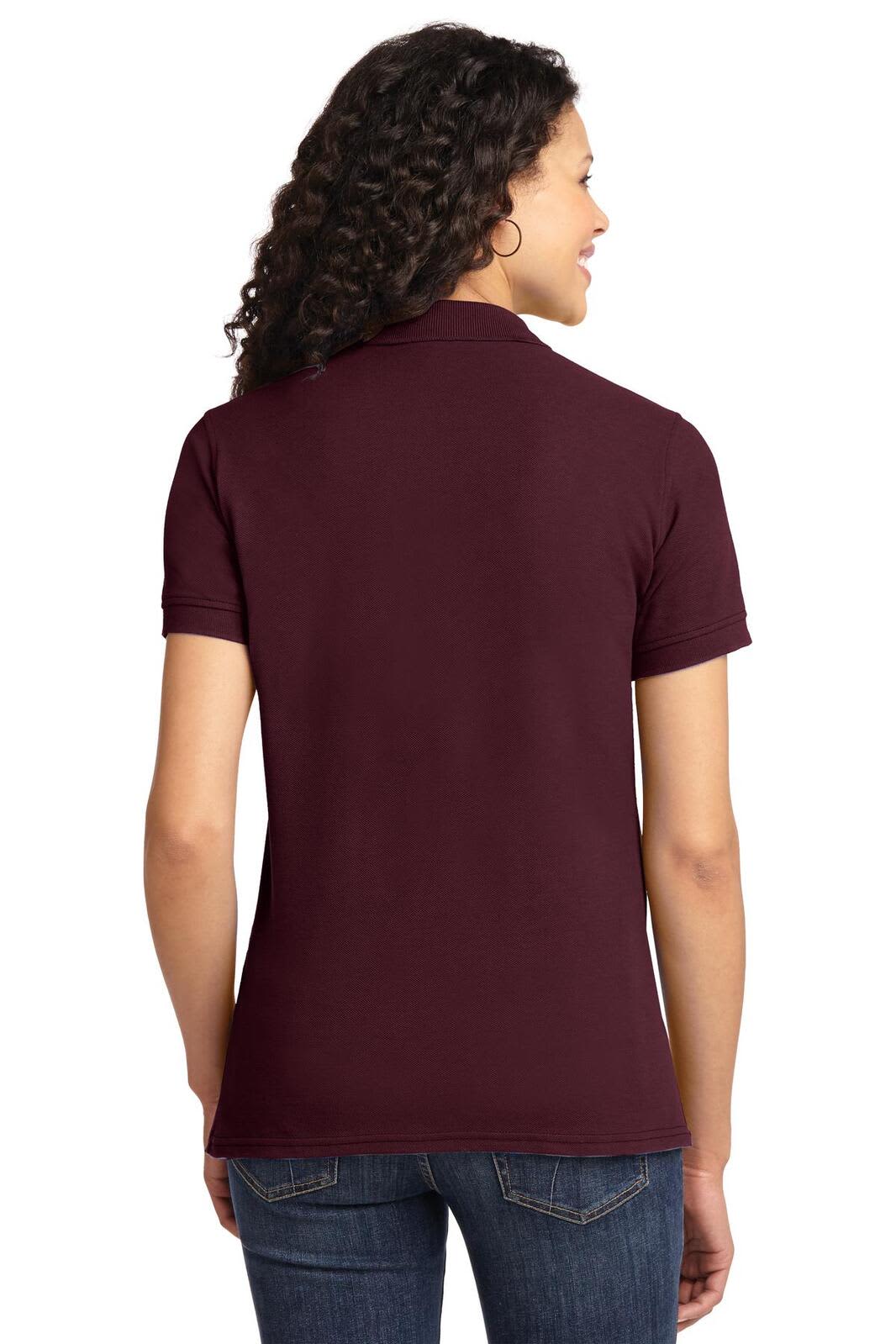 A maroon ladies' polo shirt, featuring short sleeves and a collar, with a logo on the back.