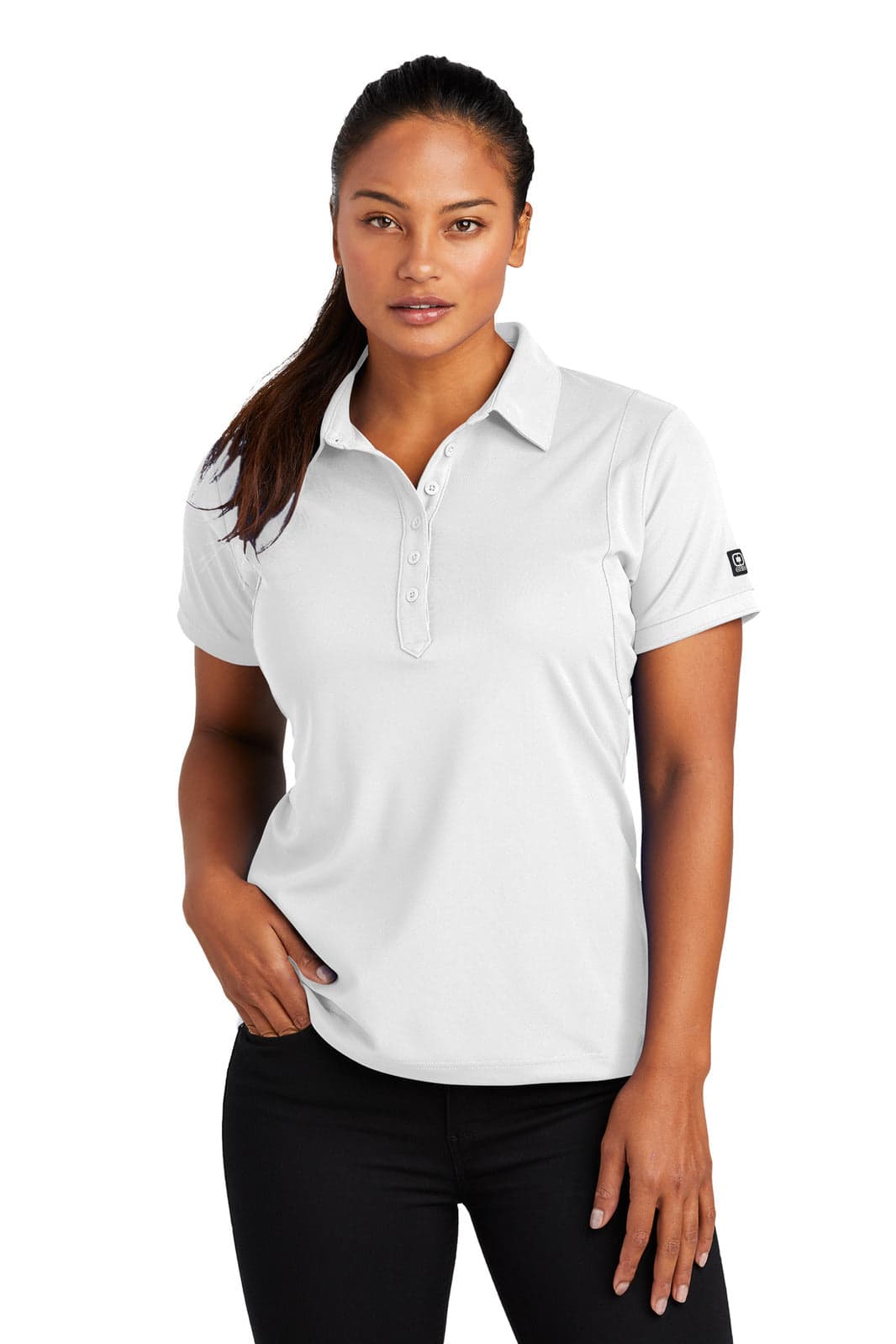 A pale grey polo shirt on a model, featuring a button placket and a logo on the sleeve.