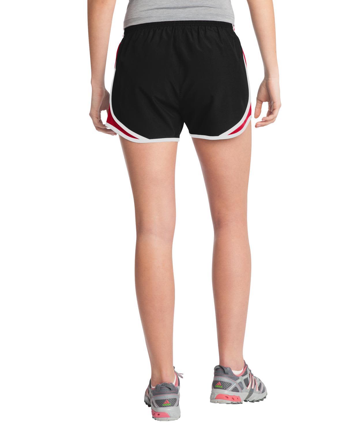 A pair of black sports shorts with red and white accents, featuring an elastic waistband and a logo.