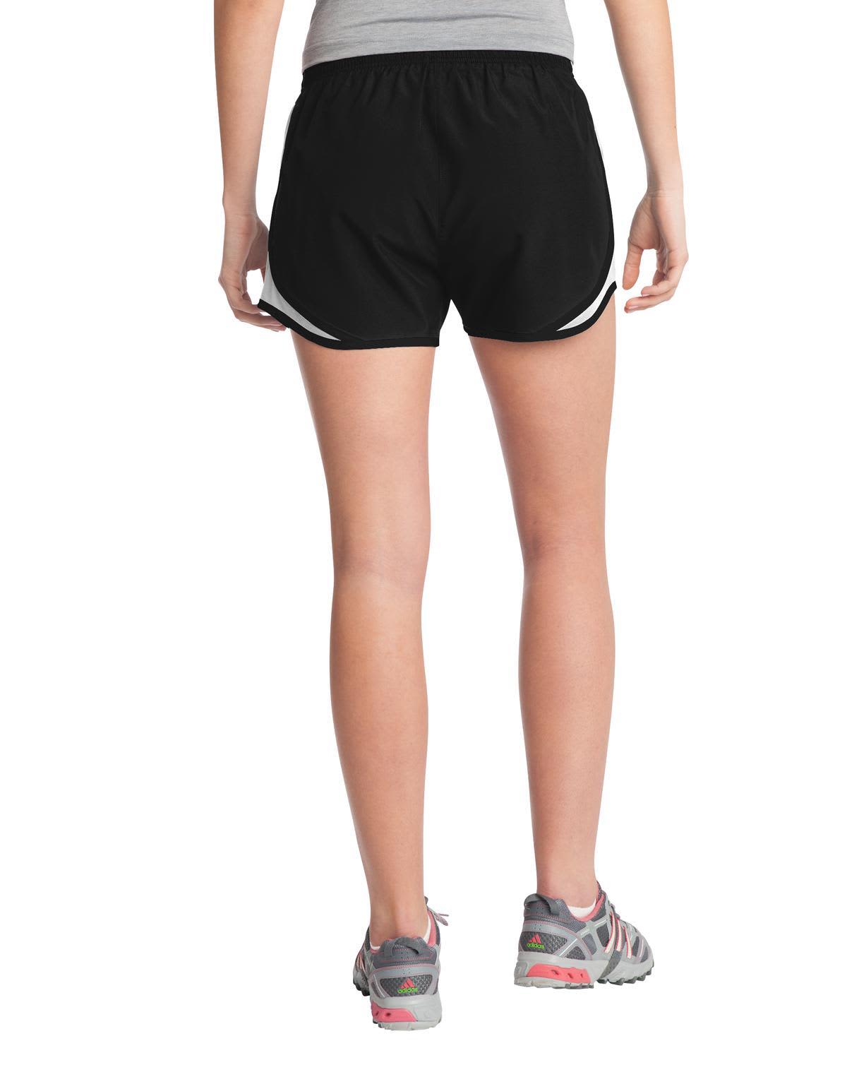 Black sports shorts featuring white accents, designed for women, displayed from the back with a logo visible.
