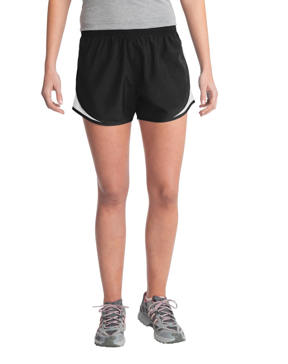 A pair of black sports shorts featuring white accents, designed for women, with an elastic waistband and a logo.