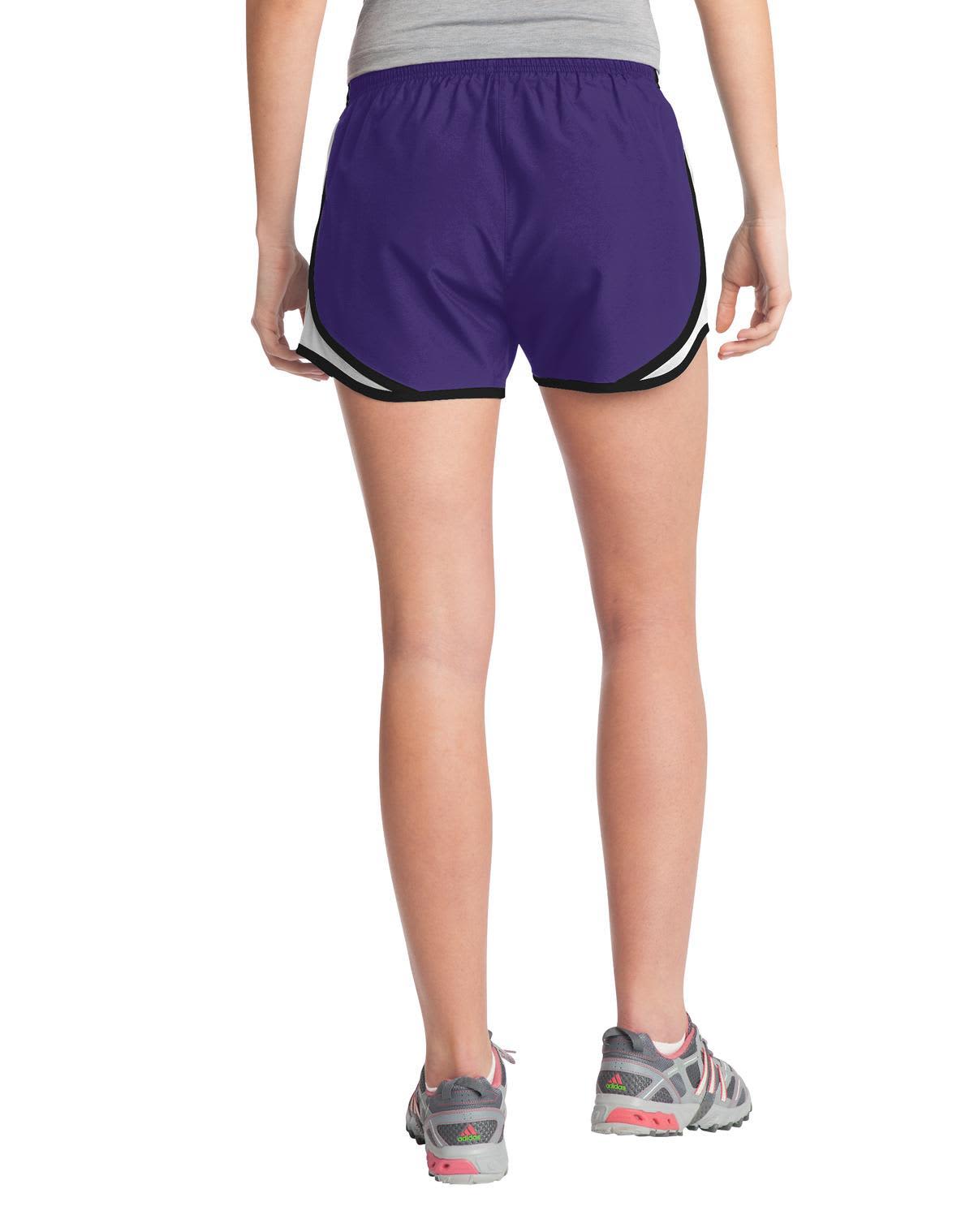 A pair of purple sports shorts with black and white accents, featuring a logo on the side.