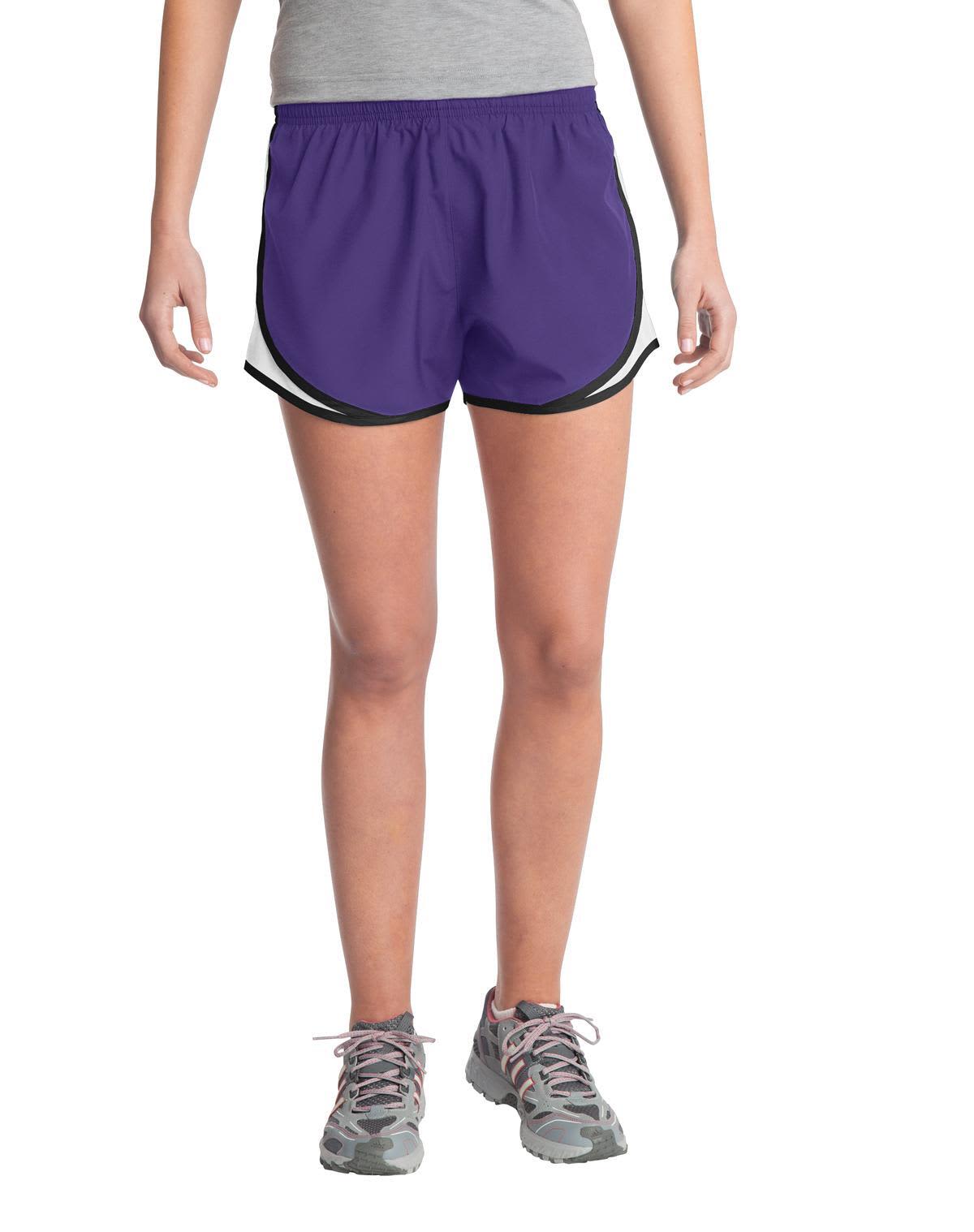 A pair of purple ladies' sports shorts featuring black trim and a logo. Ideal for athletic wear.