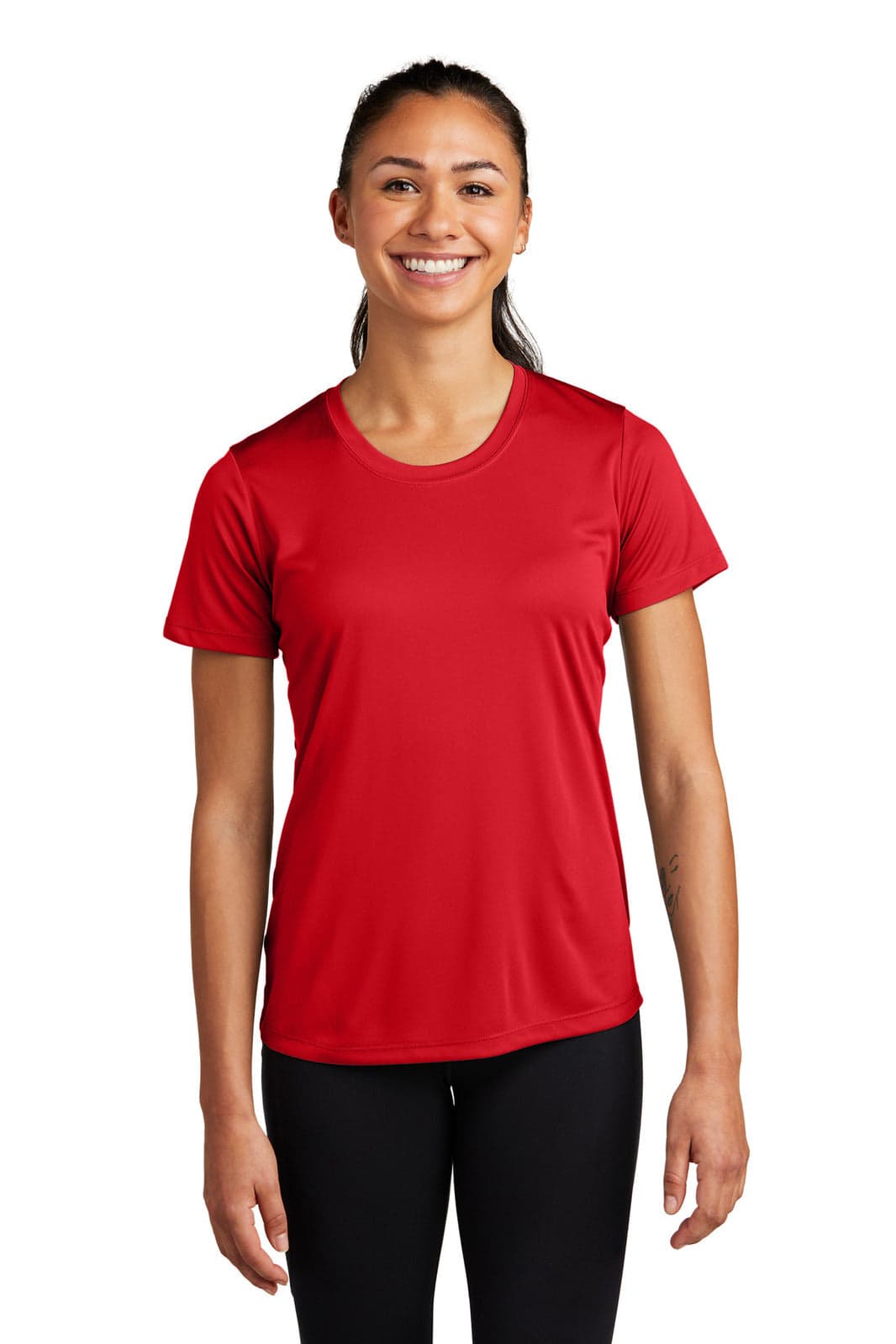 A woman wearing a red Sport-Tek Ladies PosiCharge Competitor Tee, featuring a logo on the chest.