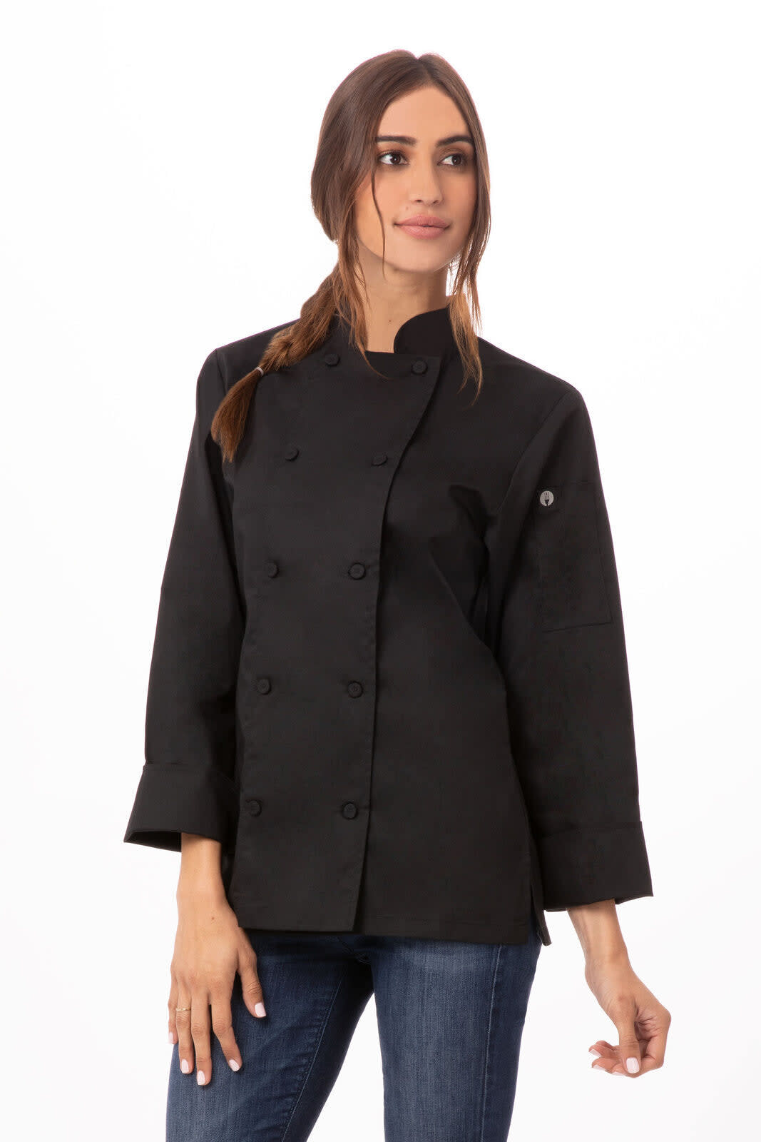 A black women's chef jacket with a double-breasted design, featuring a logo on the sleeve and worn with denim jeans.