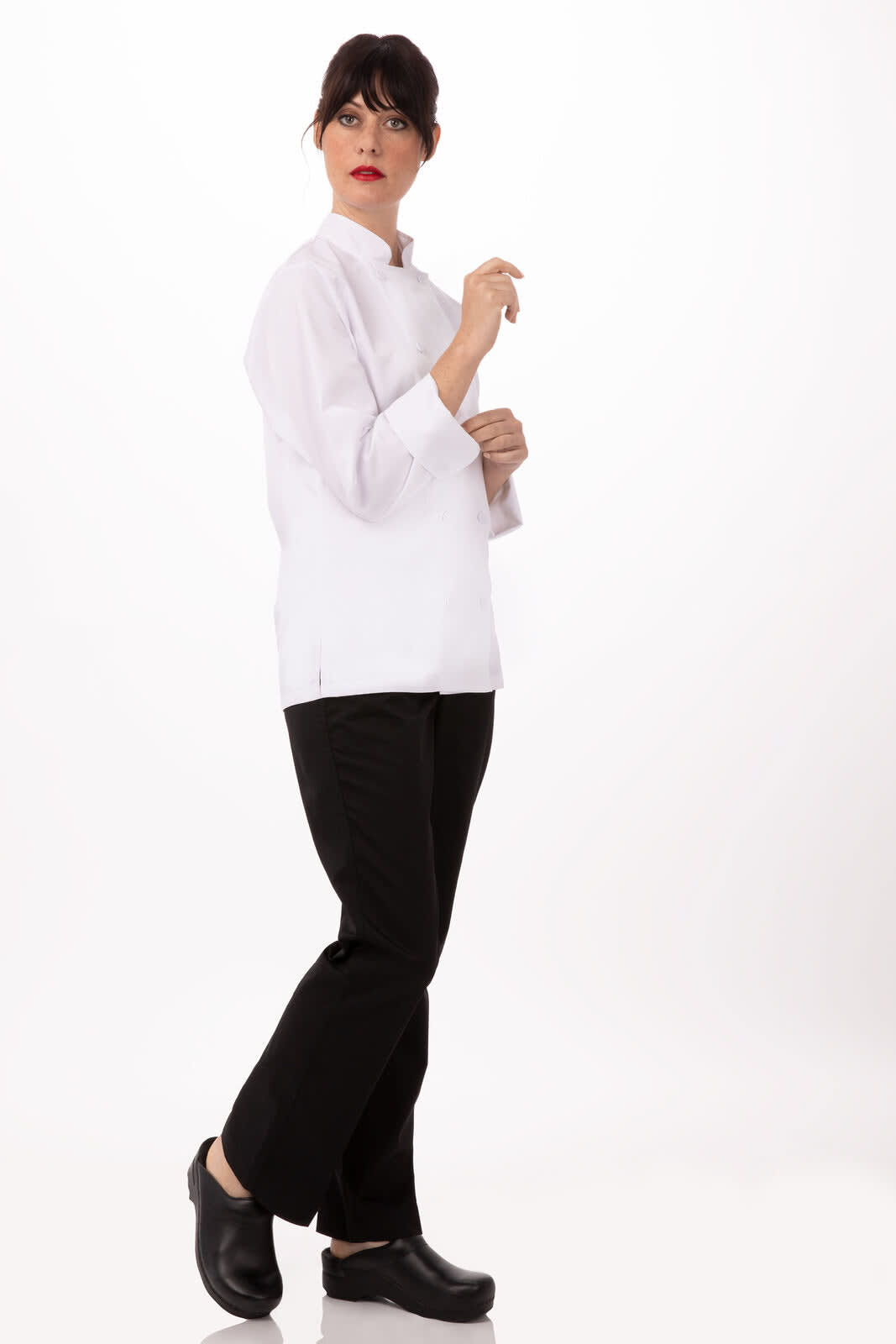 A white women's chef jacket paired with black trousers and shoes, modelled by a woman in a neutral background.