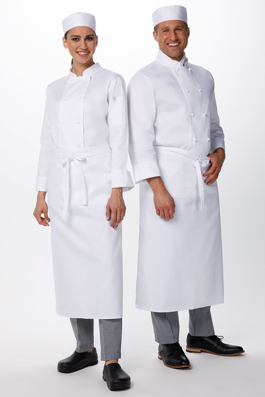 A white chef jacket worn by a male and female model, both in chef hats, with aprons and grey trousers.