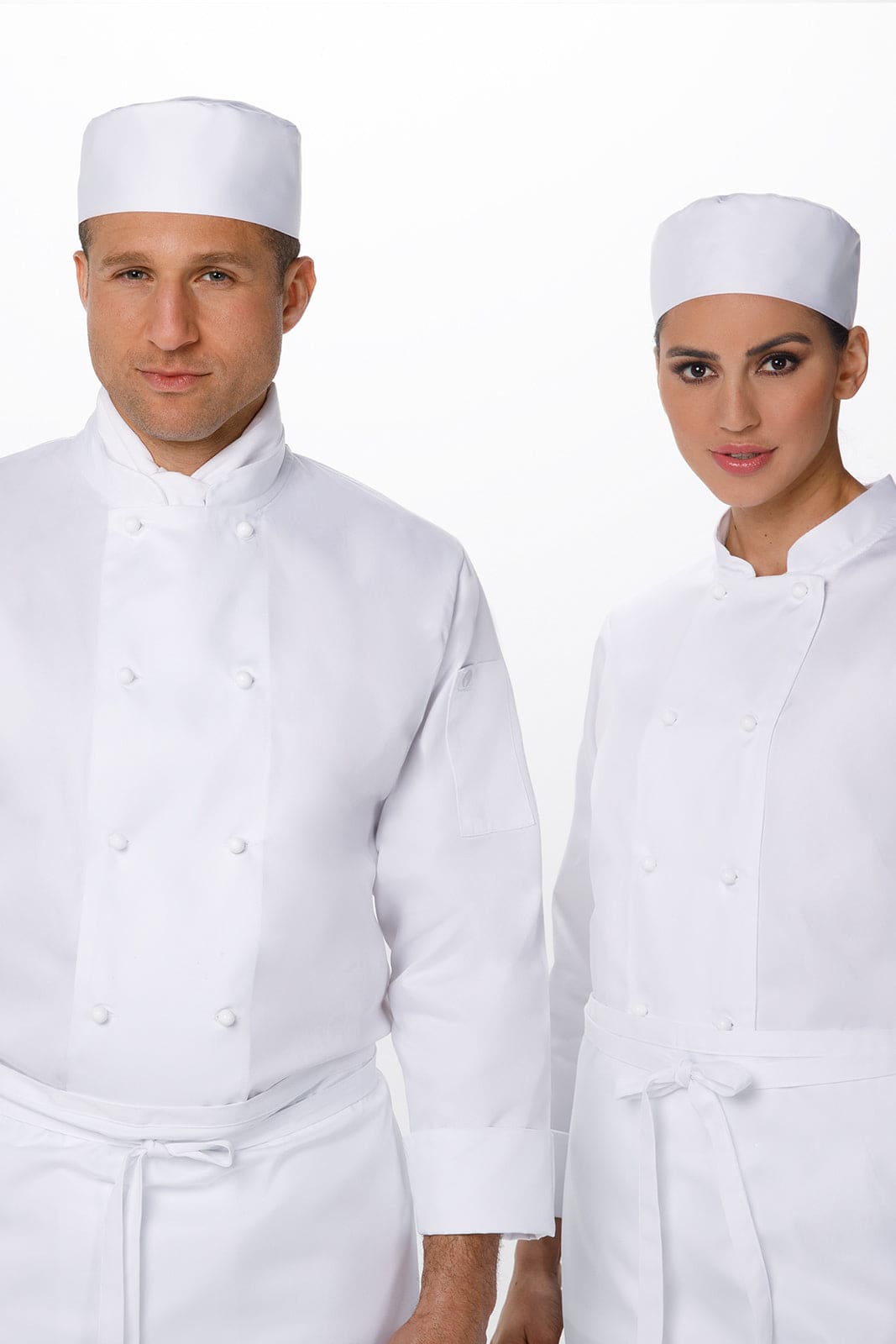 Two chefs wearing white jackets and matching white hats pose for the camera, showcasing their professional attire.