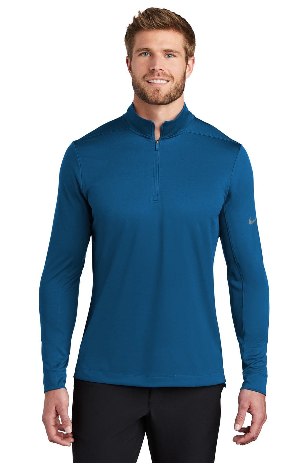 A blue Nike Dry 1/2-Zip Cover-Up, featuring long sleeves and a zipper at the neck, displayed on a male model.