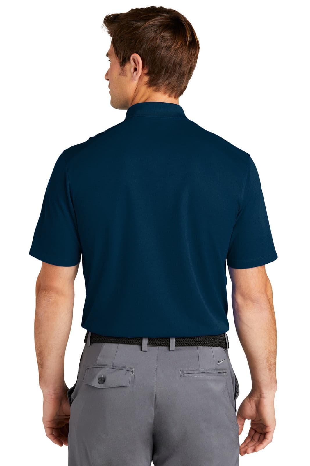 A man wearing a navy blue polo shirt, viewed from the back, with short sleeves and a collar.