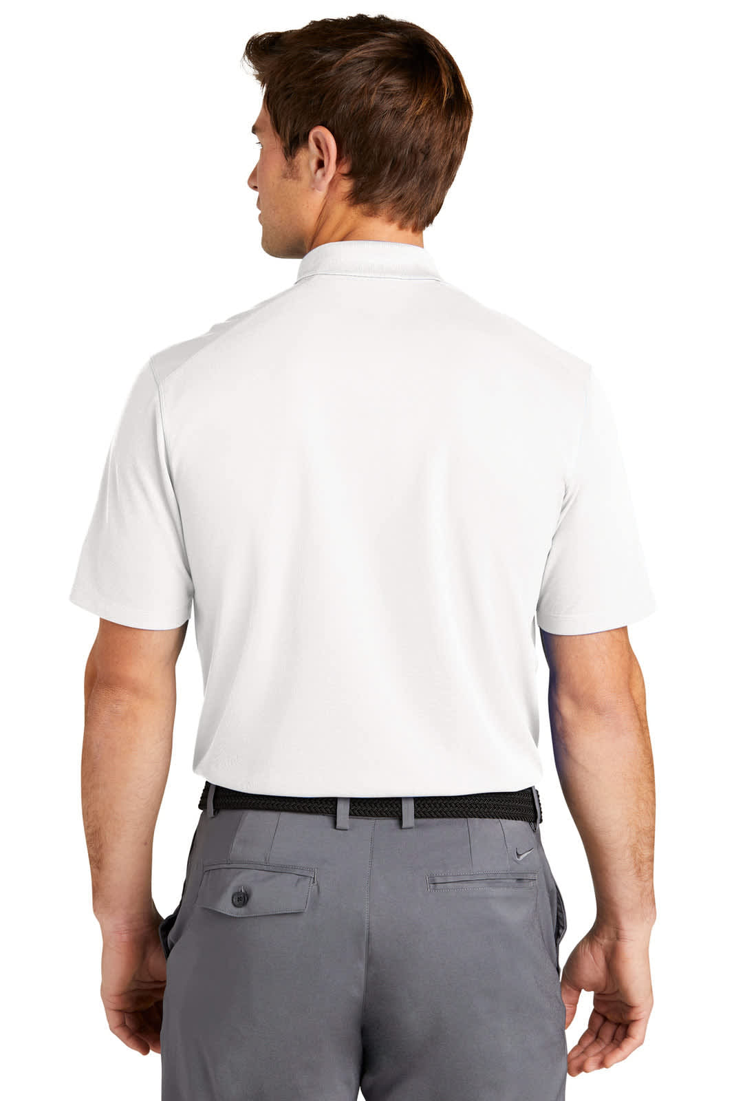 A man is wearing a white Nike Dri-FIT Micro Pique 2.0 Polo, viewed from the back, paired with grey trousers.