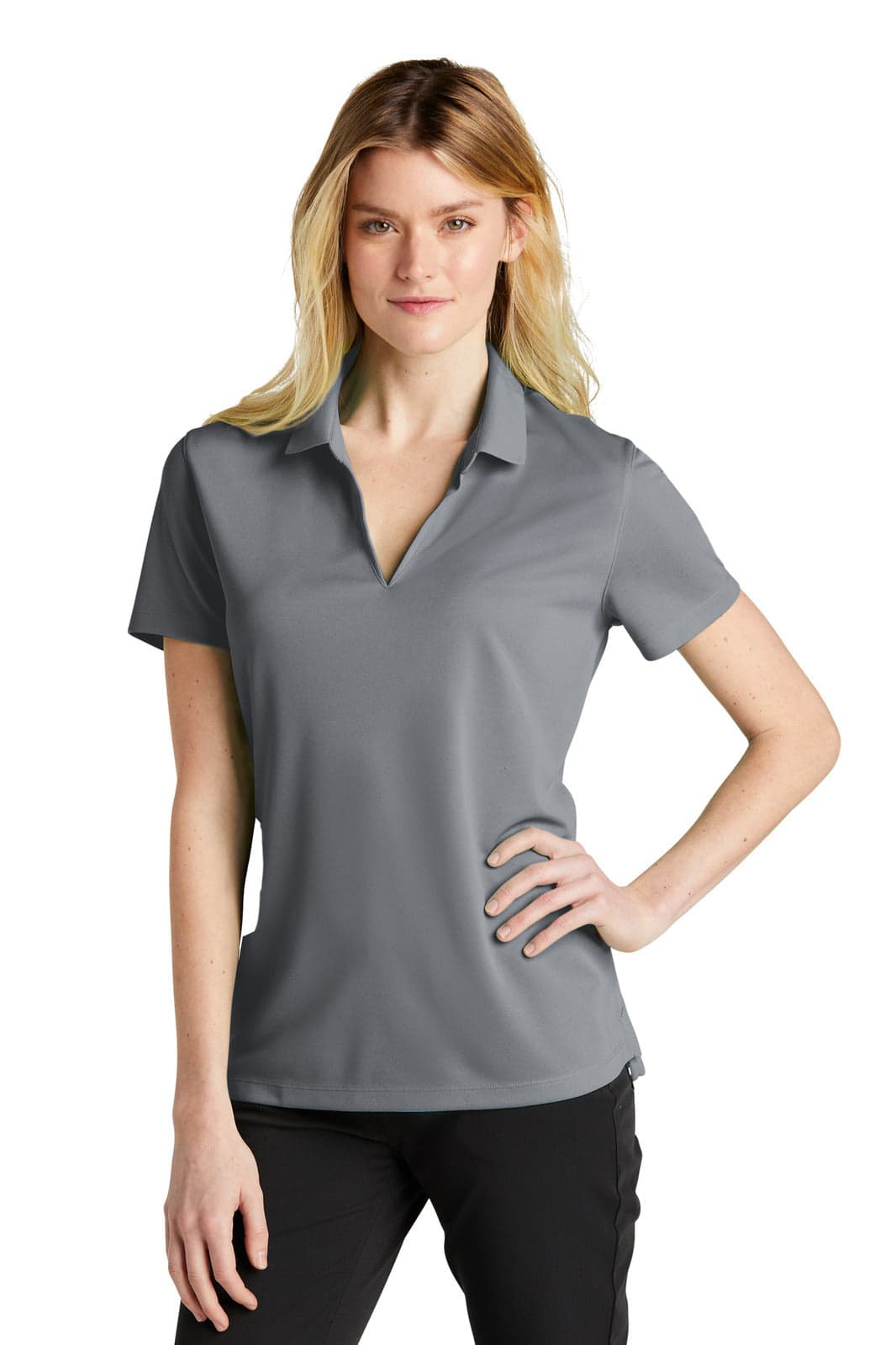 A grey Nike Ladies Dri-FIT Micro Pique 2.0 Polo shirt displayed on a model, featuring a collar and short sleeves.