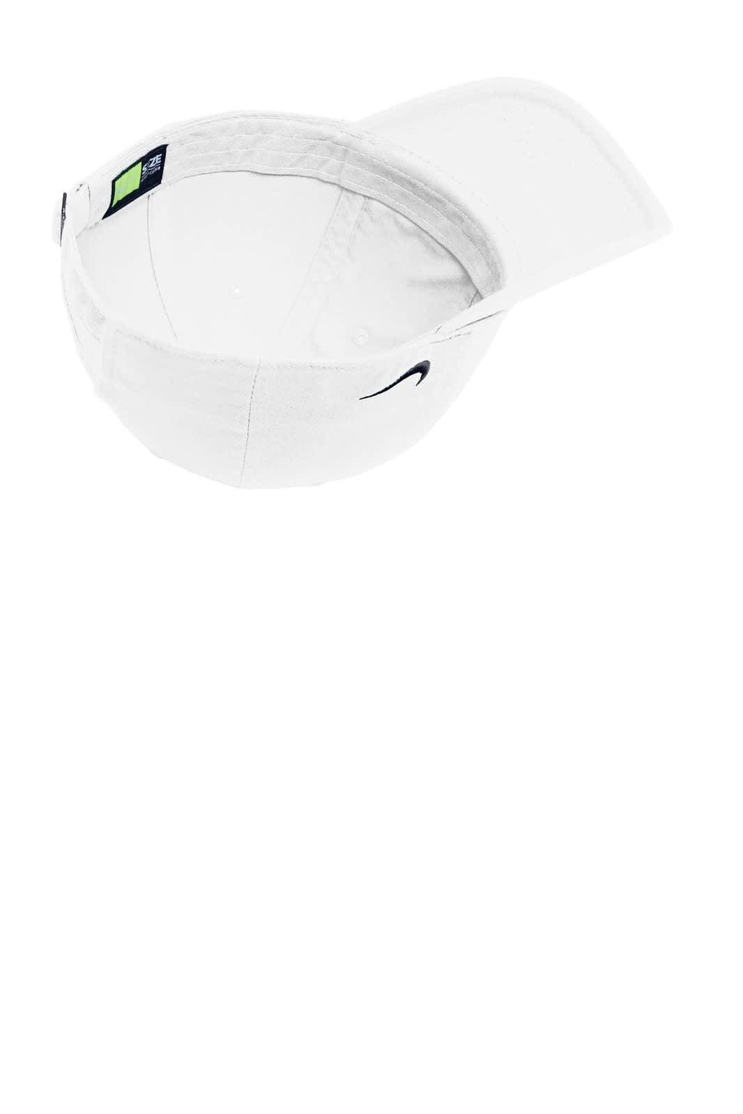 A white Nike Heritage 86 cap featuring a curved brim and an interior lining. The cap has a logo.