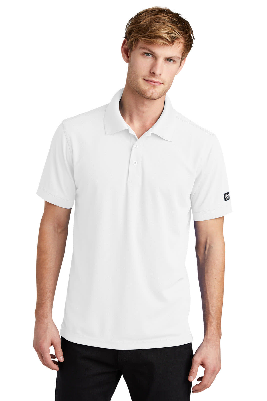 A white OGIO Caliber 2.0 polo shirt on a mannequin, featuring a logo on the sleeve.
