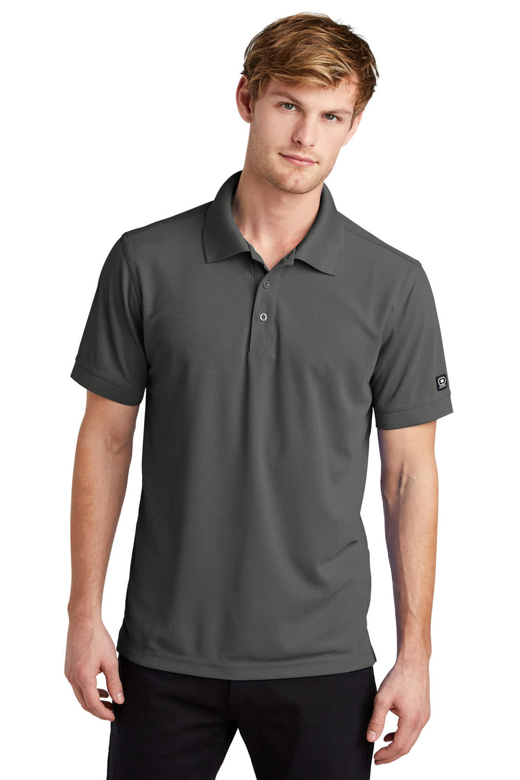 A polo shirt in dark grey, featuring a collar, short sleeves, and a logo on the sleeve.