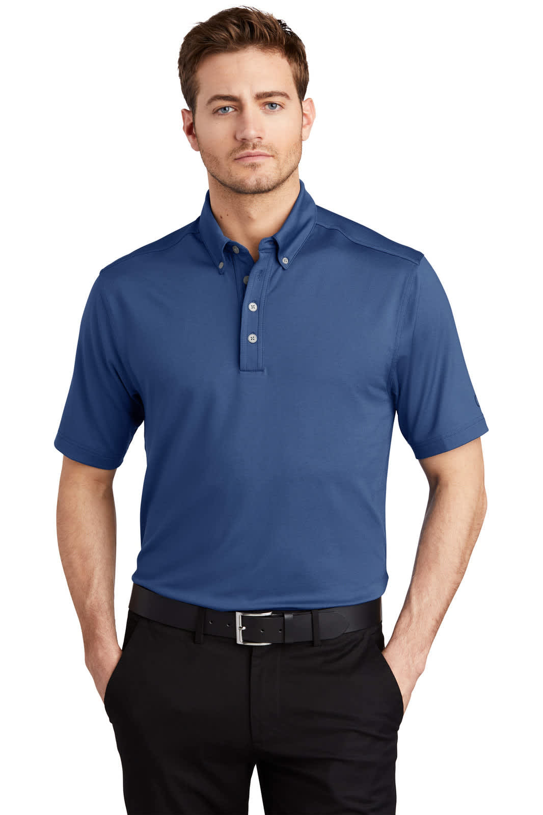 A blue OGIO Gauge Polo shirt is worn by a man standing against a plain background. The shirt features a collar and branding.