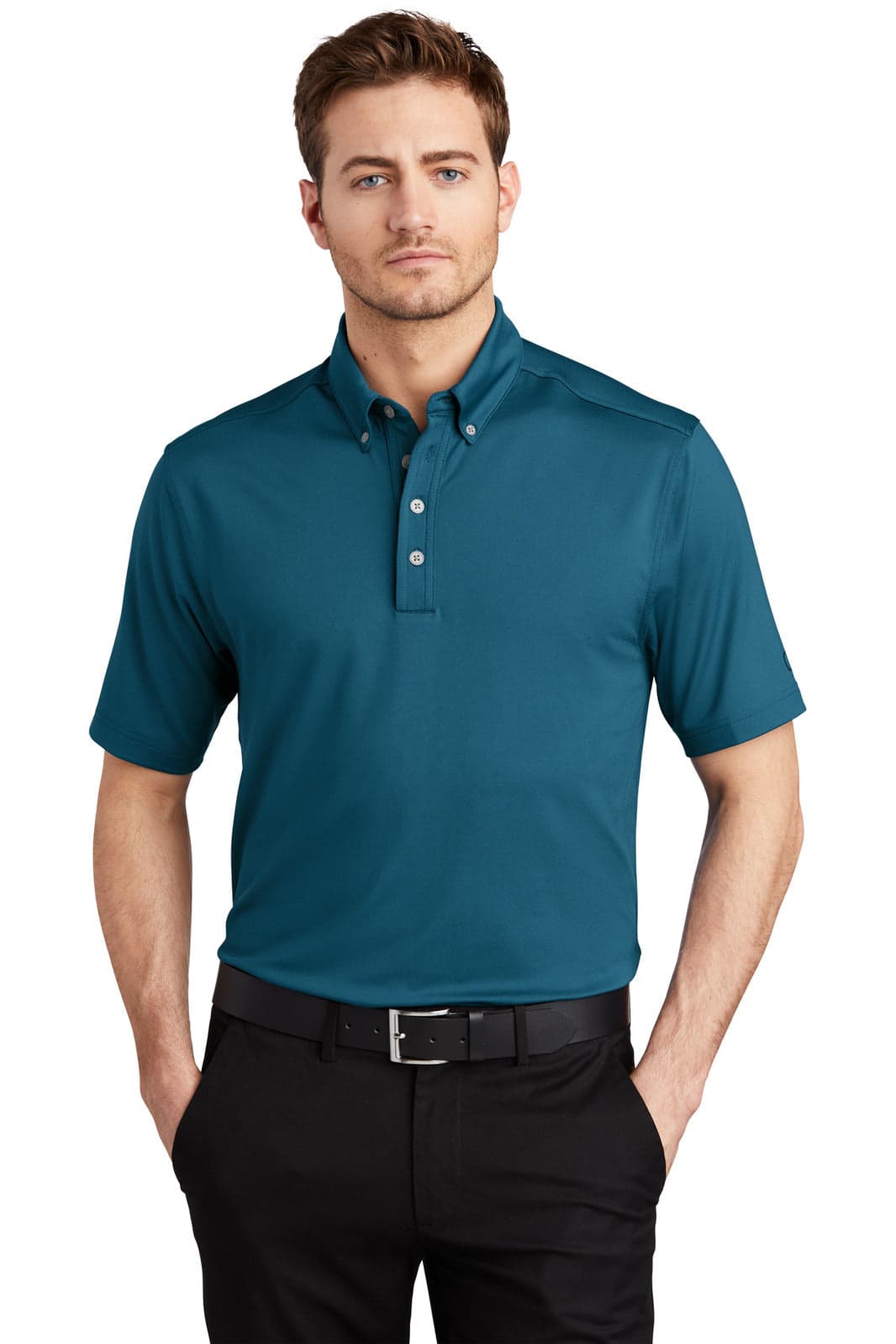 A teal OGIO Gauge Polo shirt with a collar, short sleeves, and a logo. Worn by a model standing confidently.