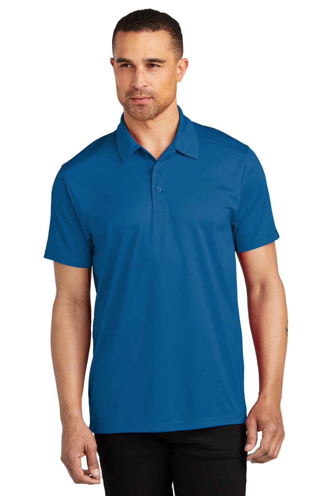 A man is wearing a short-sleeved polo shirt in a vibrant blue colour. The shirt features a collar and has a logo.