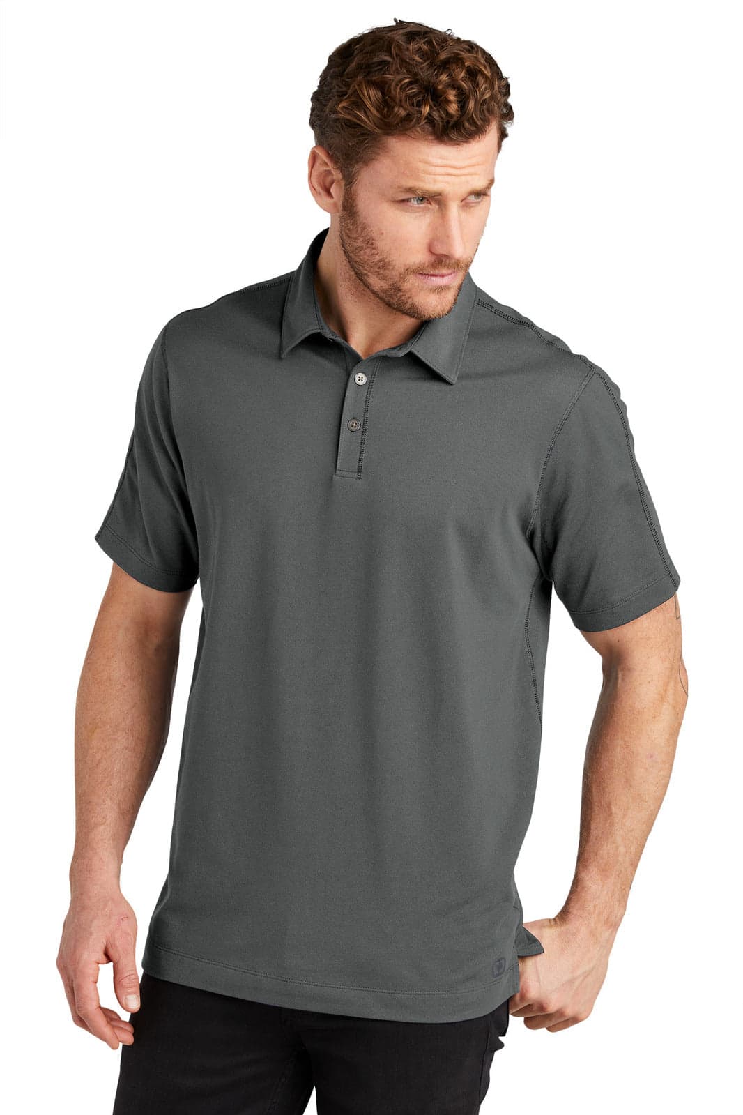 A grey polo shirt with a collar and a logo, styled on a model in a relaxed pose.
