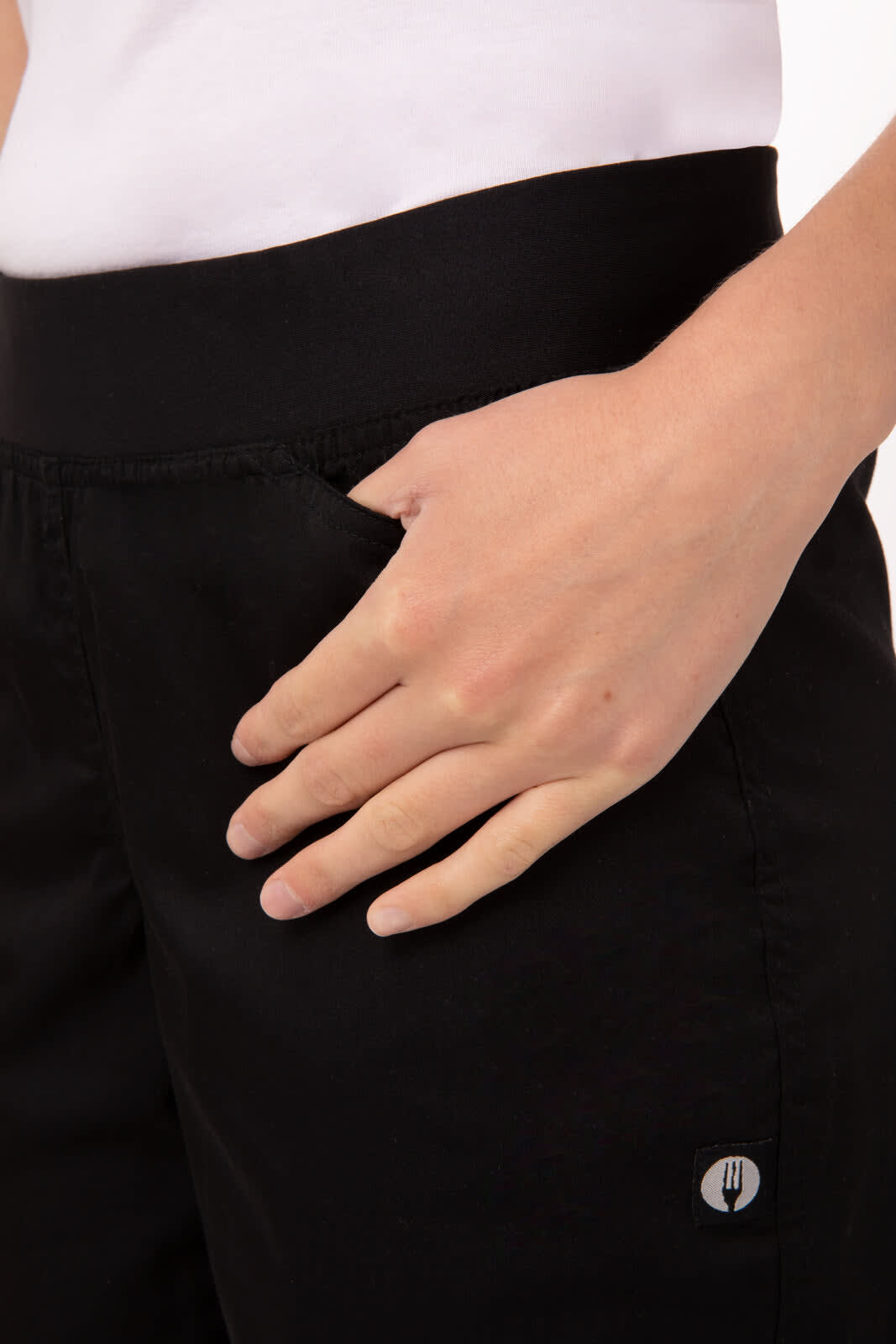 Lightweight slim women's chef pants in black, featuring a comfortable waist and side pocket detail with a logo.