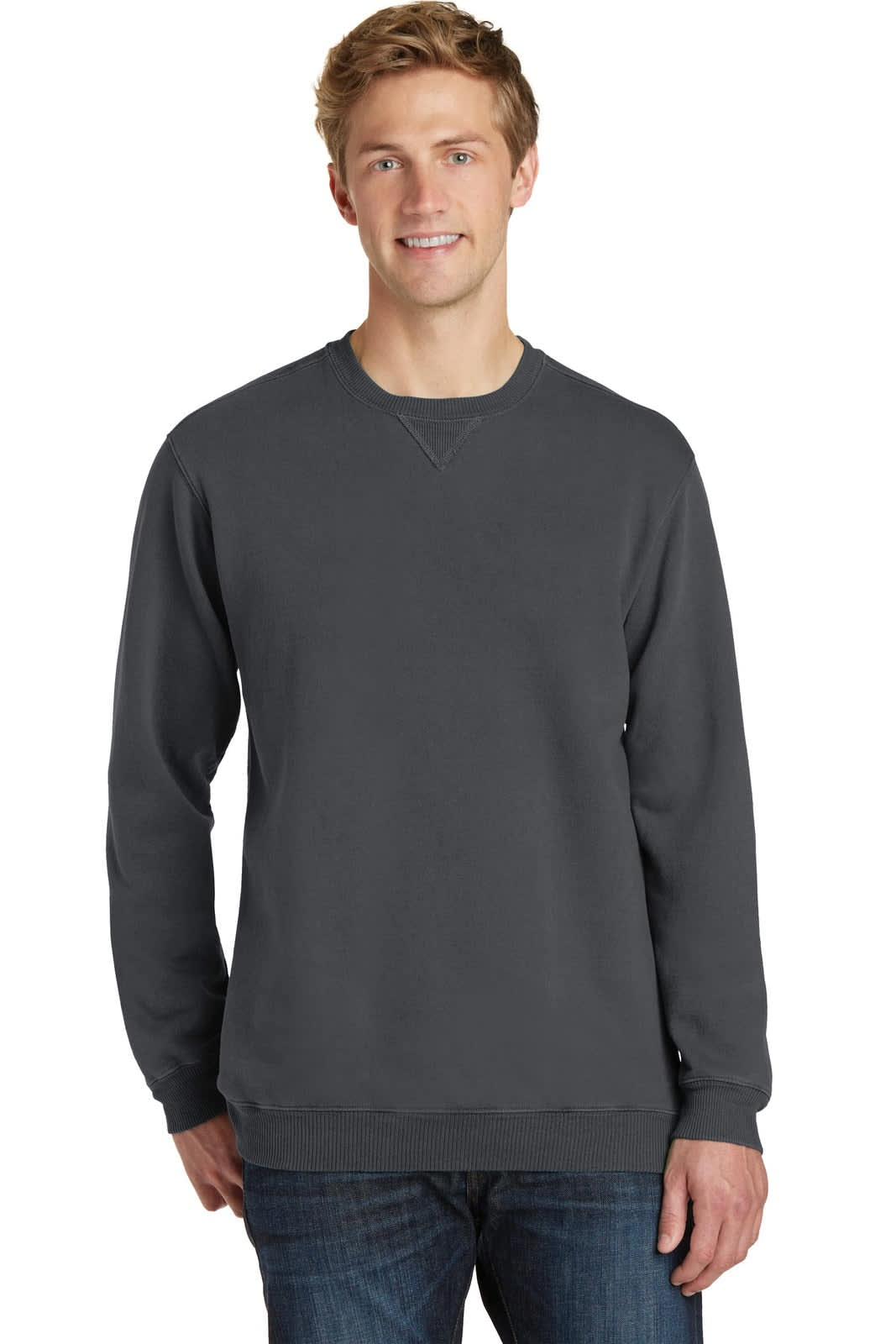 A grey crewneck sweatshirt on a model, featuring a logo and casual style, paired with dark jeans.