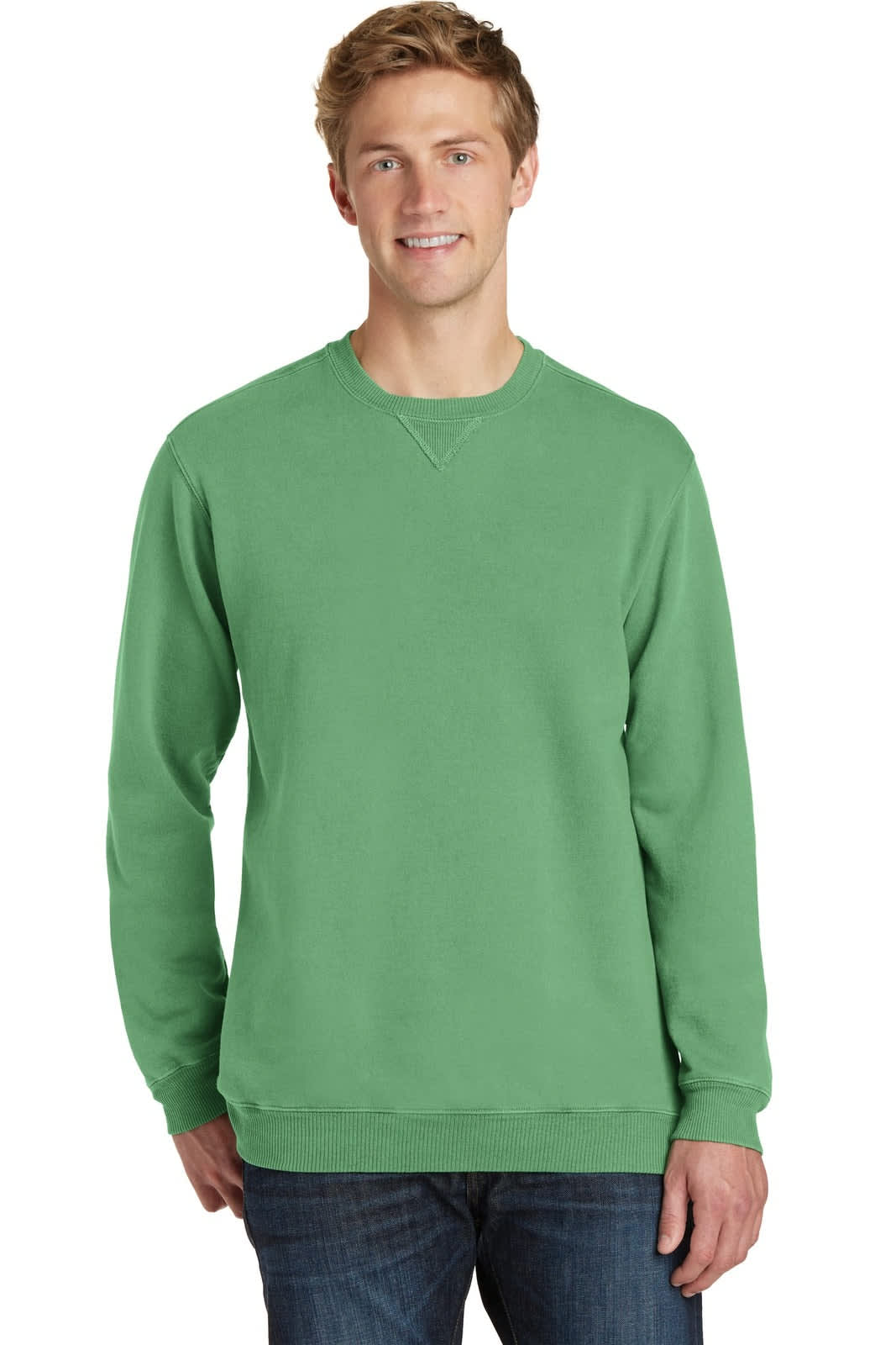 A green crewneck sweatshirt on a model, featuring long sleeves and a casual fit. It has a logo on it.