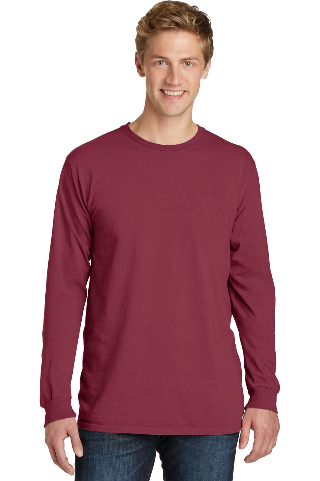 A long sleeve tee in a burgundy shade, featuring a logo, worn by a smiling model.