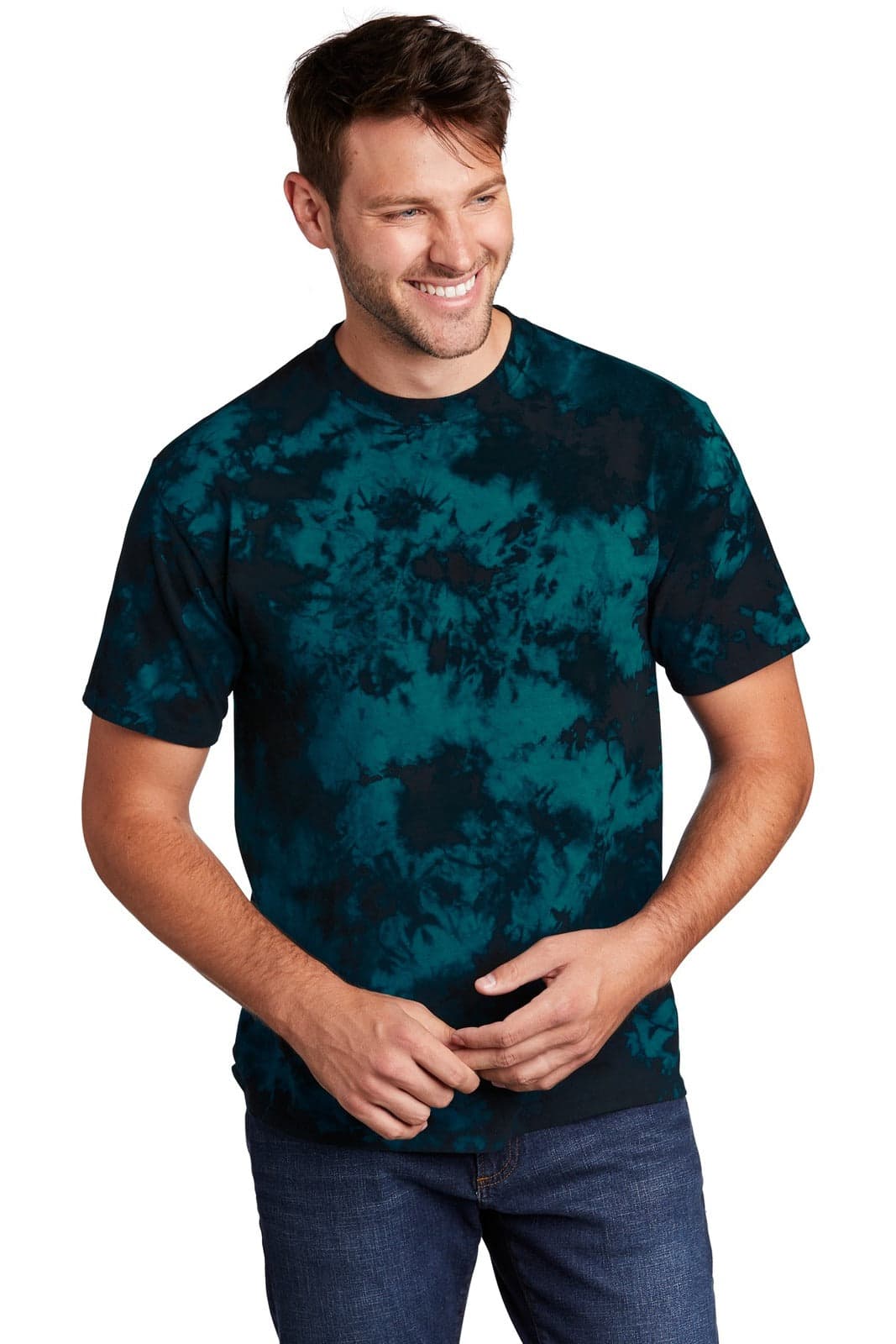 A man wearing a blue and black tie-dye t-shirt, smiling and standing against a plain background.