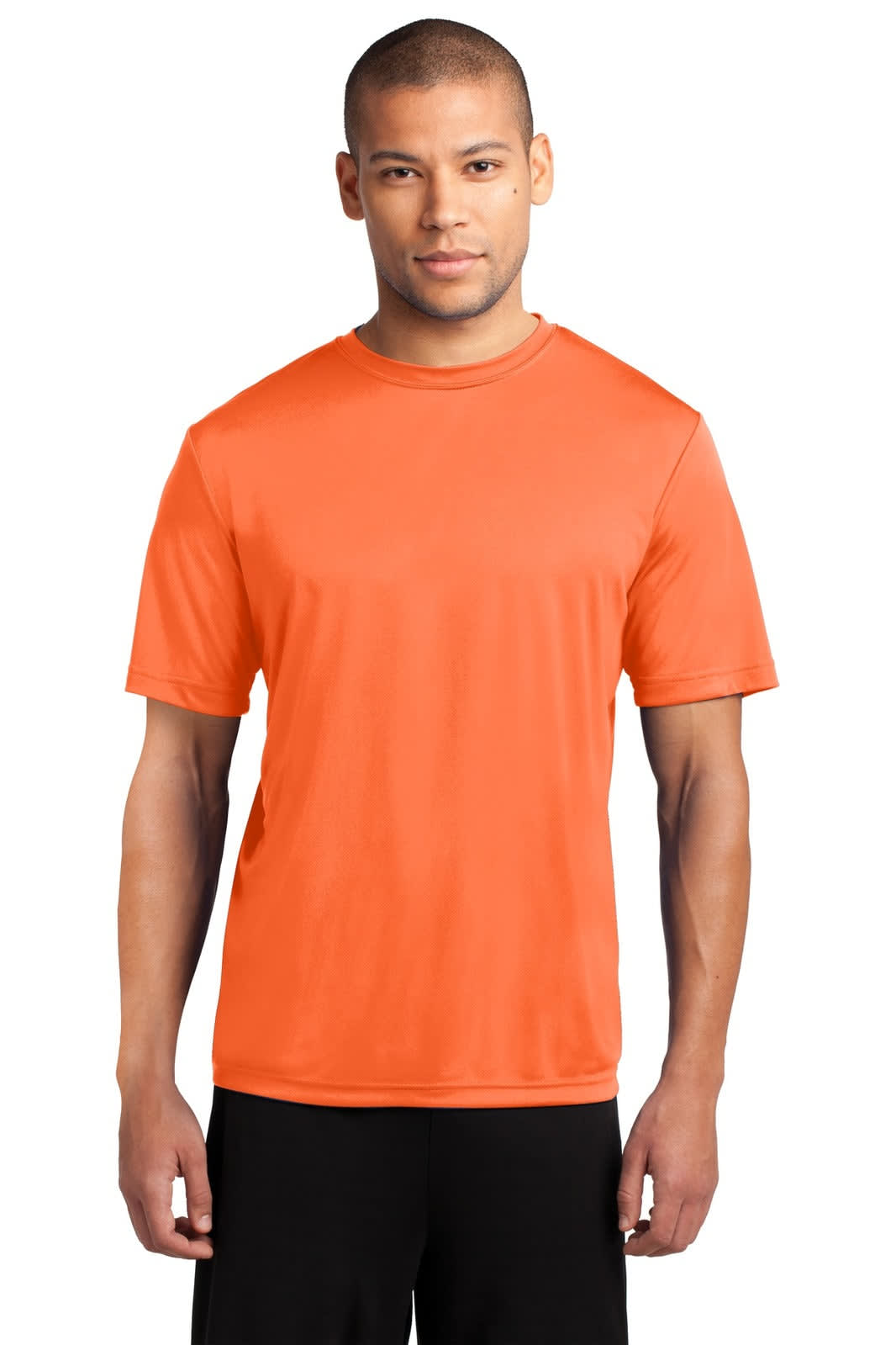 A man wearing an orange performance t-shirt, standing against a neutral background. The shirt includes a logo.