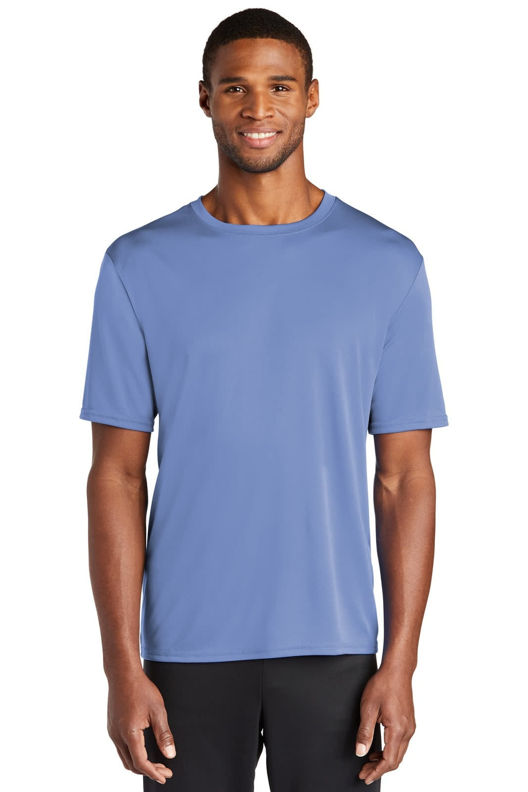 A man wearing a blue performance tee in a casual pose. The shirt has a logo on the front.
