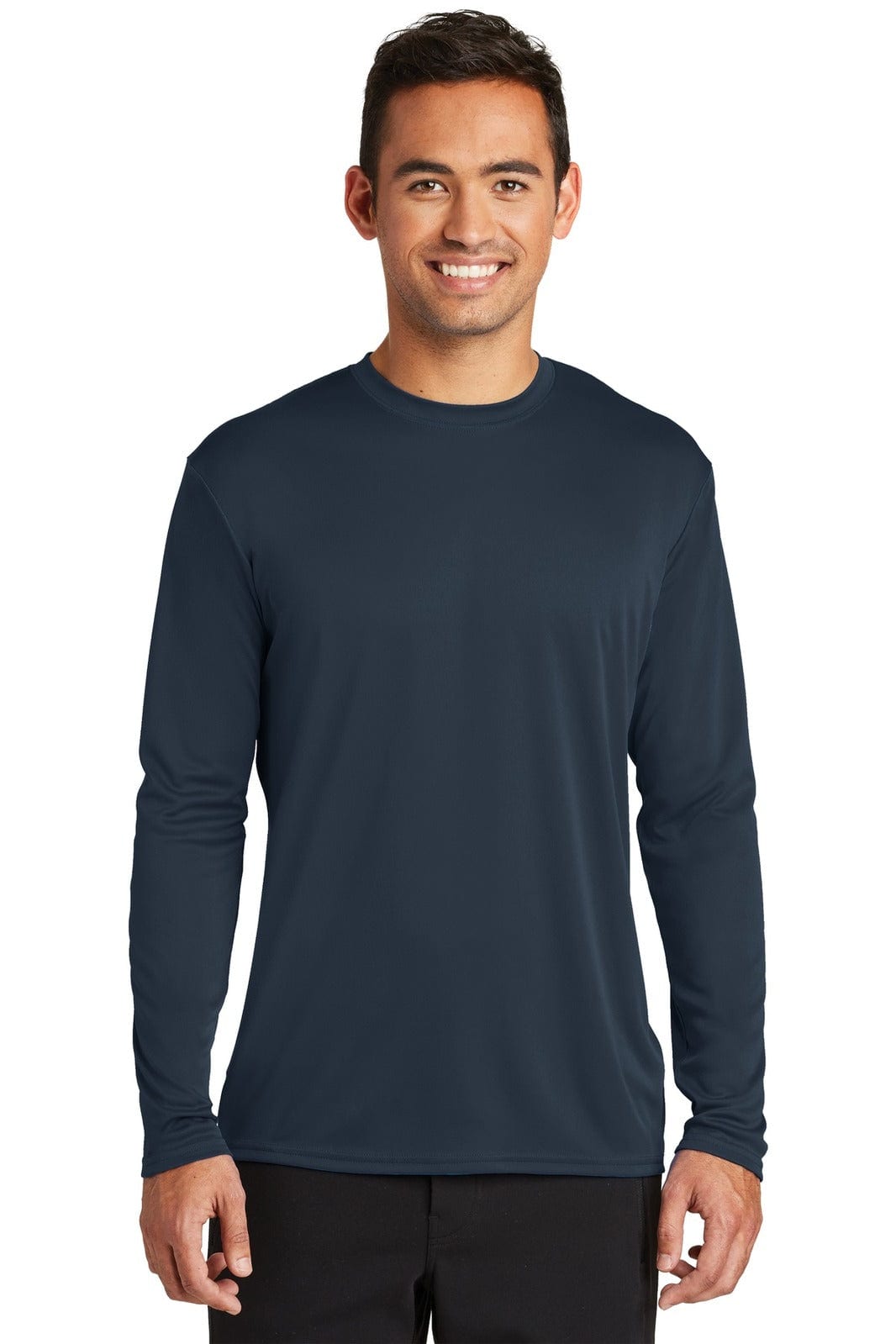 A navy long sleeve performance tee displayed on a male model with a smiling expression. The shirt features a logo.