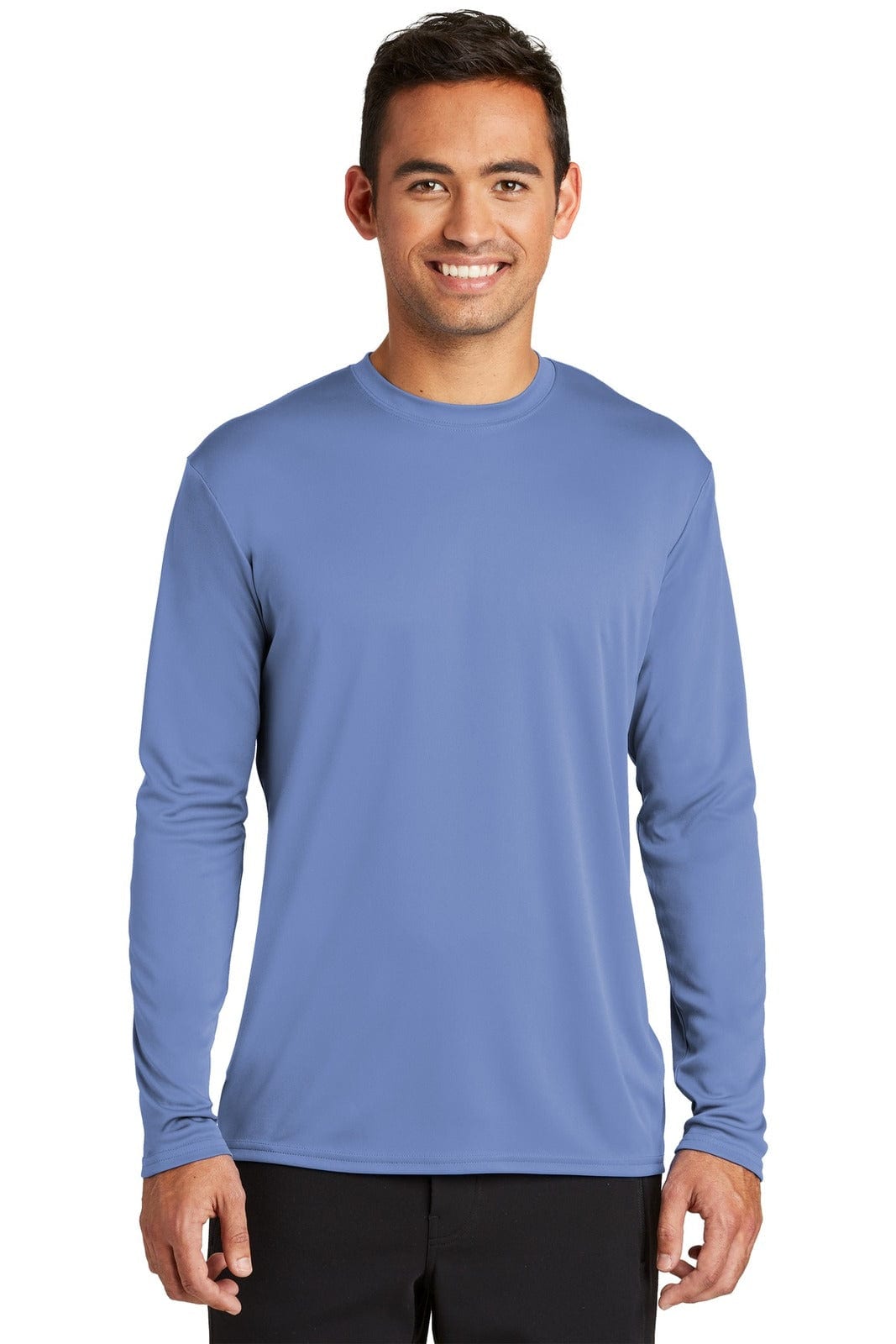 A man wearing a long sleeve performance tee in blue, featuring a logo on it and a relaxed fit.