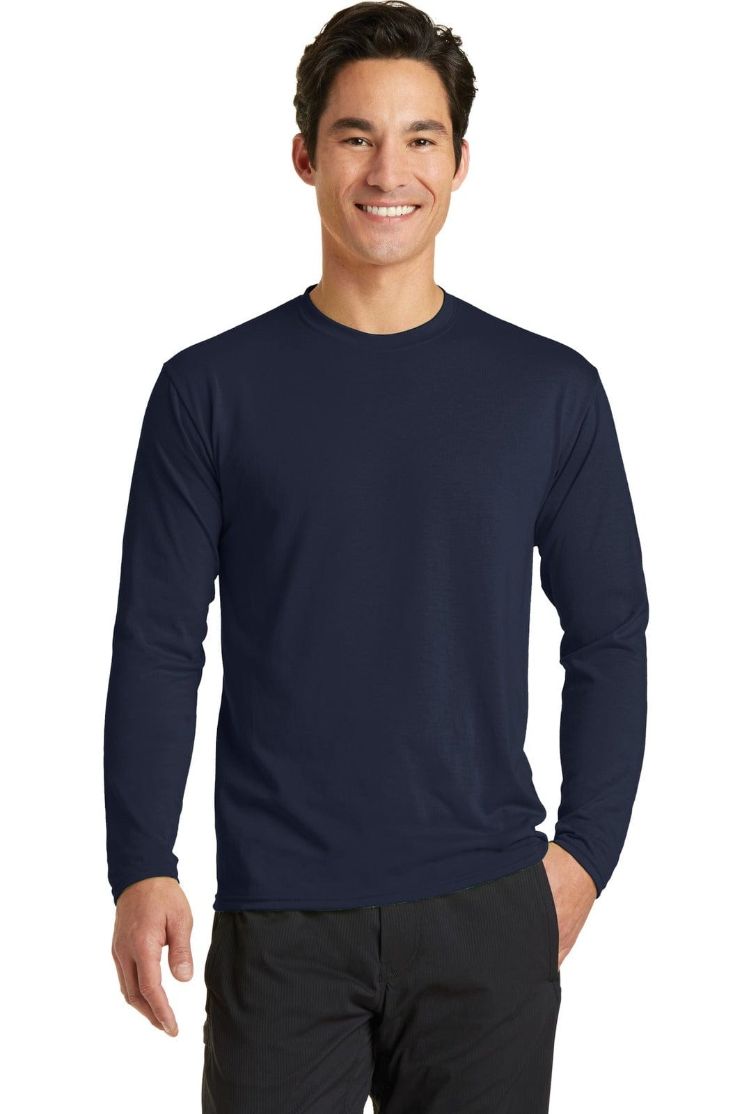 A man is wearing a navy long sleeve performance blend tee, featuring a simple design and a logo.
